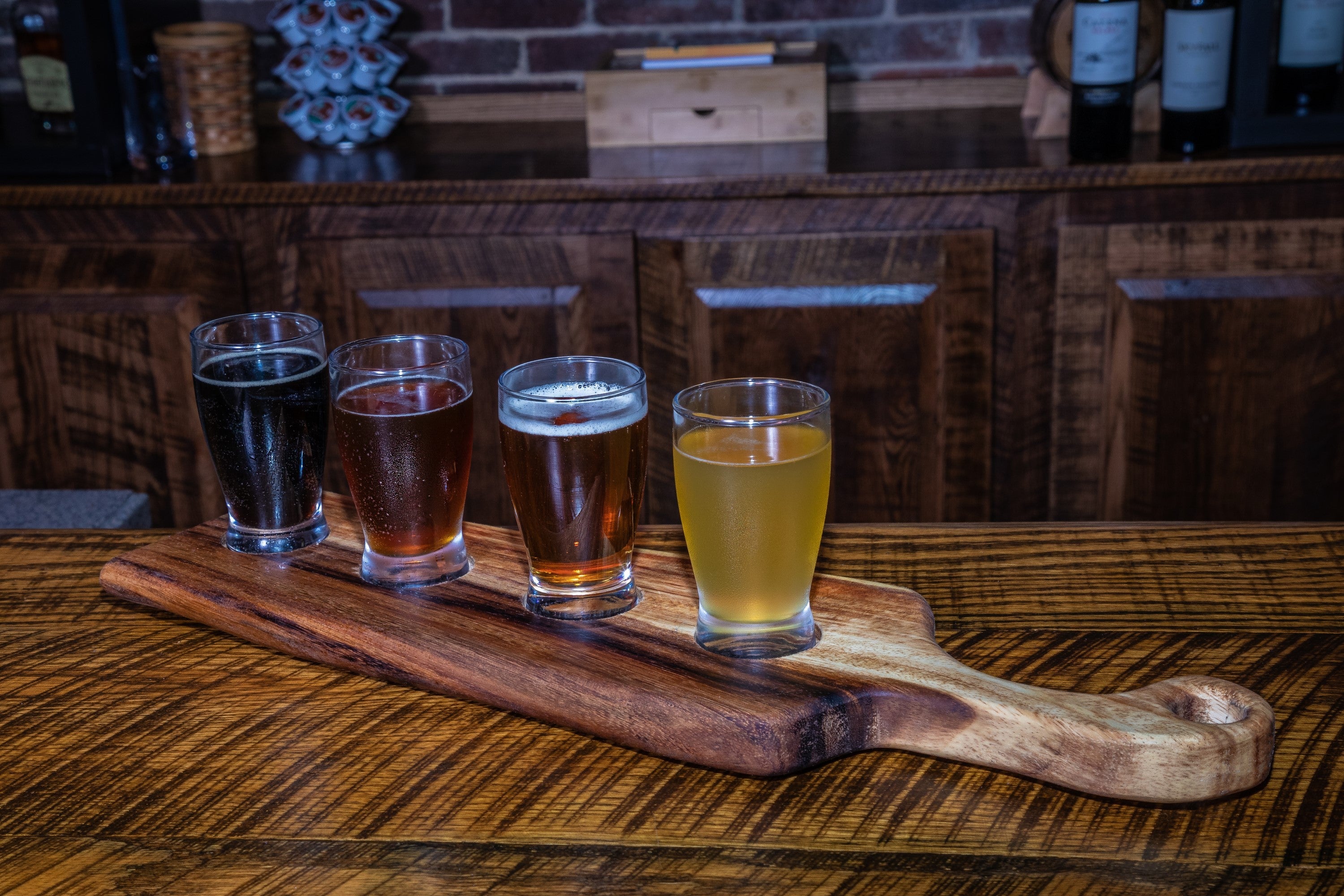 Medium live edge handled bread board made from East Indian Walnut on tabletop