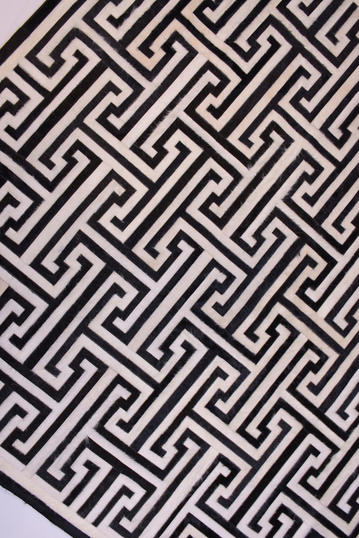 T Model – Maze-Inspired Cowhide Patch Rug by Homelosophy