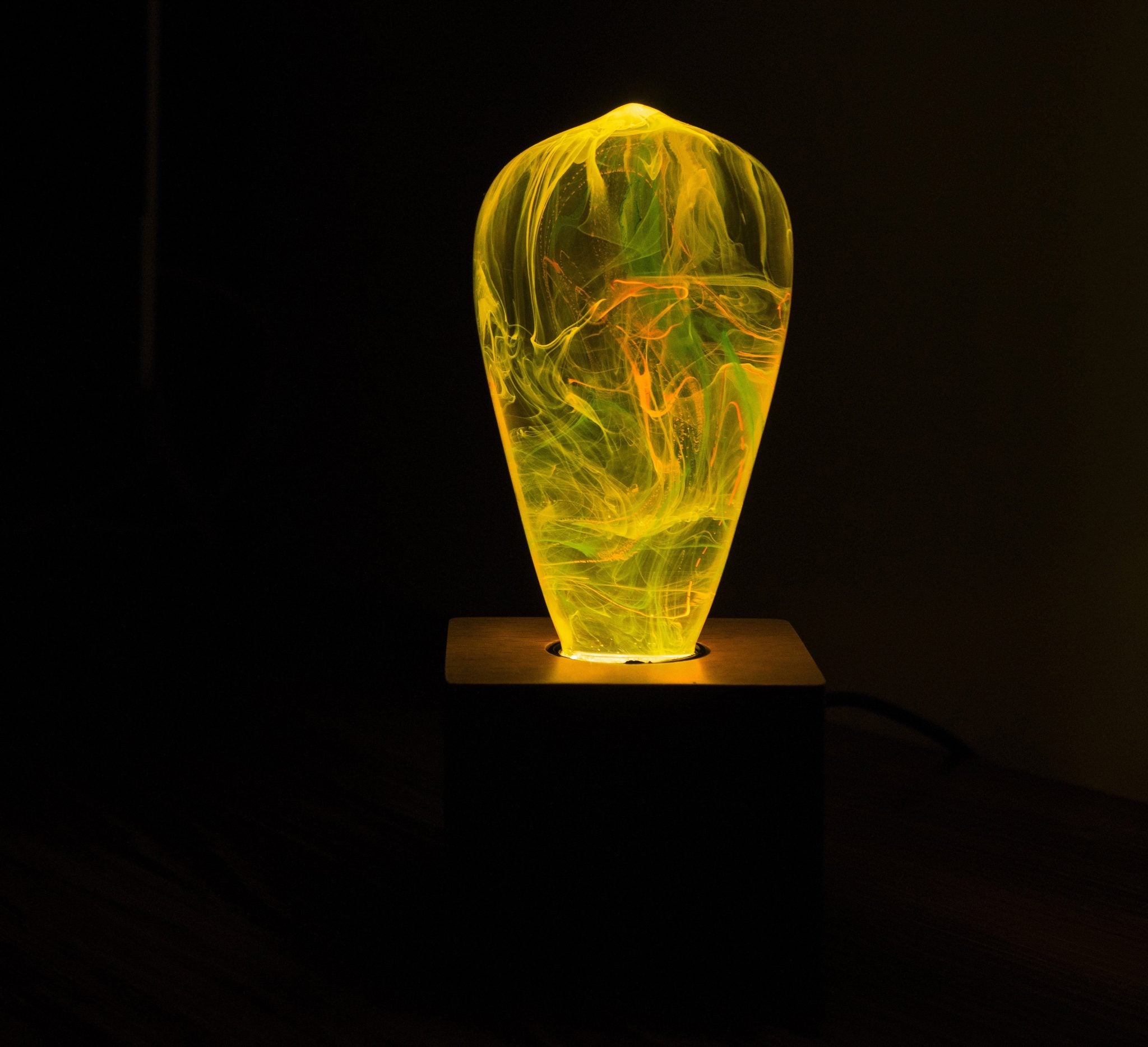 Three handcrafted resin LED light bulbs in a bundle, showing unique color patterns and resin designs