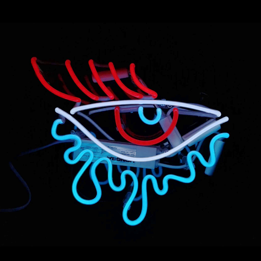 Eye Tear Neon Light Sign lit in pink against a white wall
