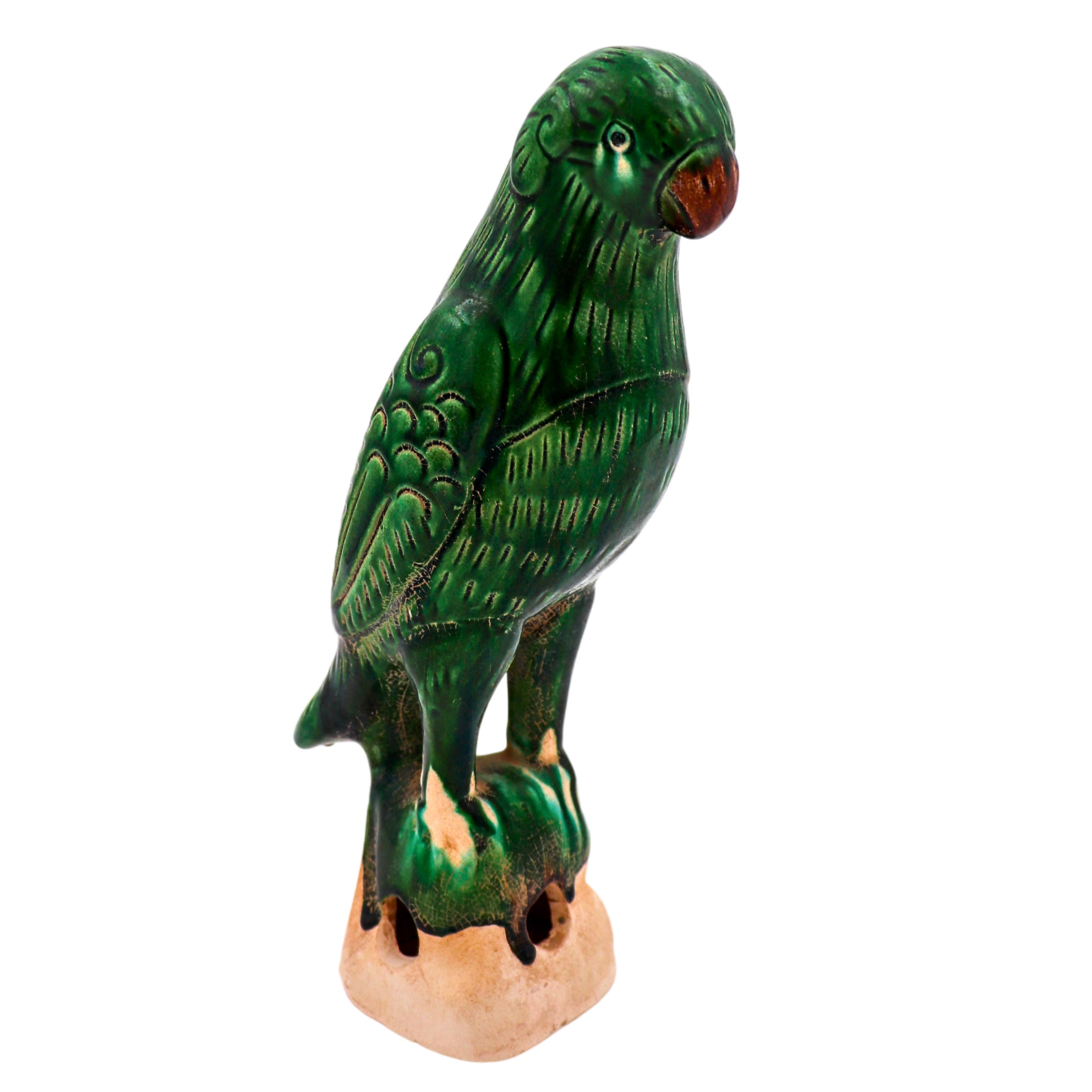 Hand-painted green ceramic figurine of a parrot standing tall with a regal posture
