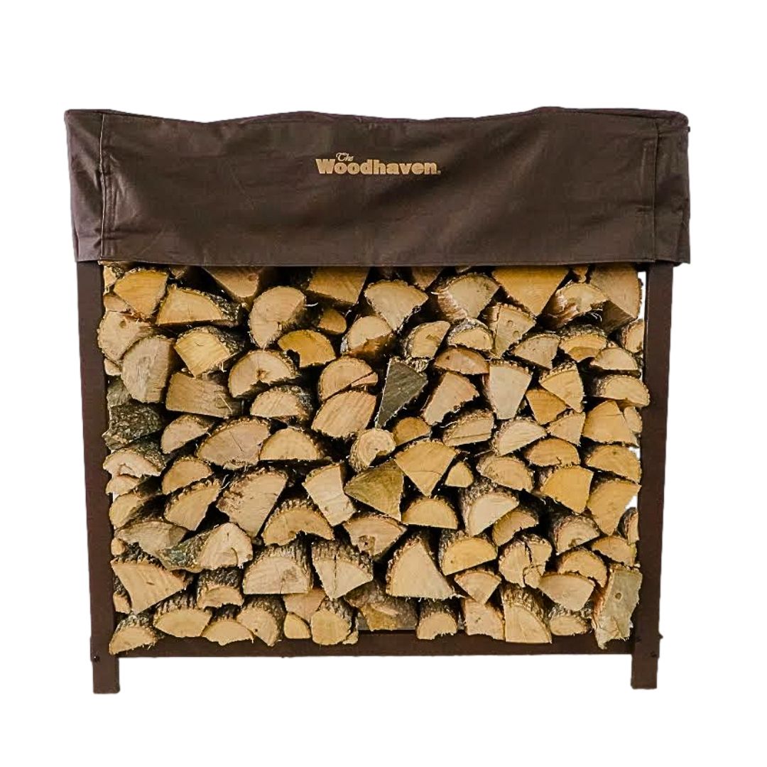 The Woodhaven 5 ft Firewood Rack in black showing stacked firewood on a patio