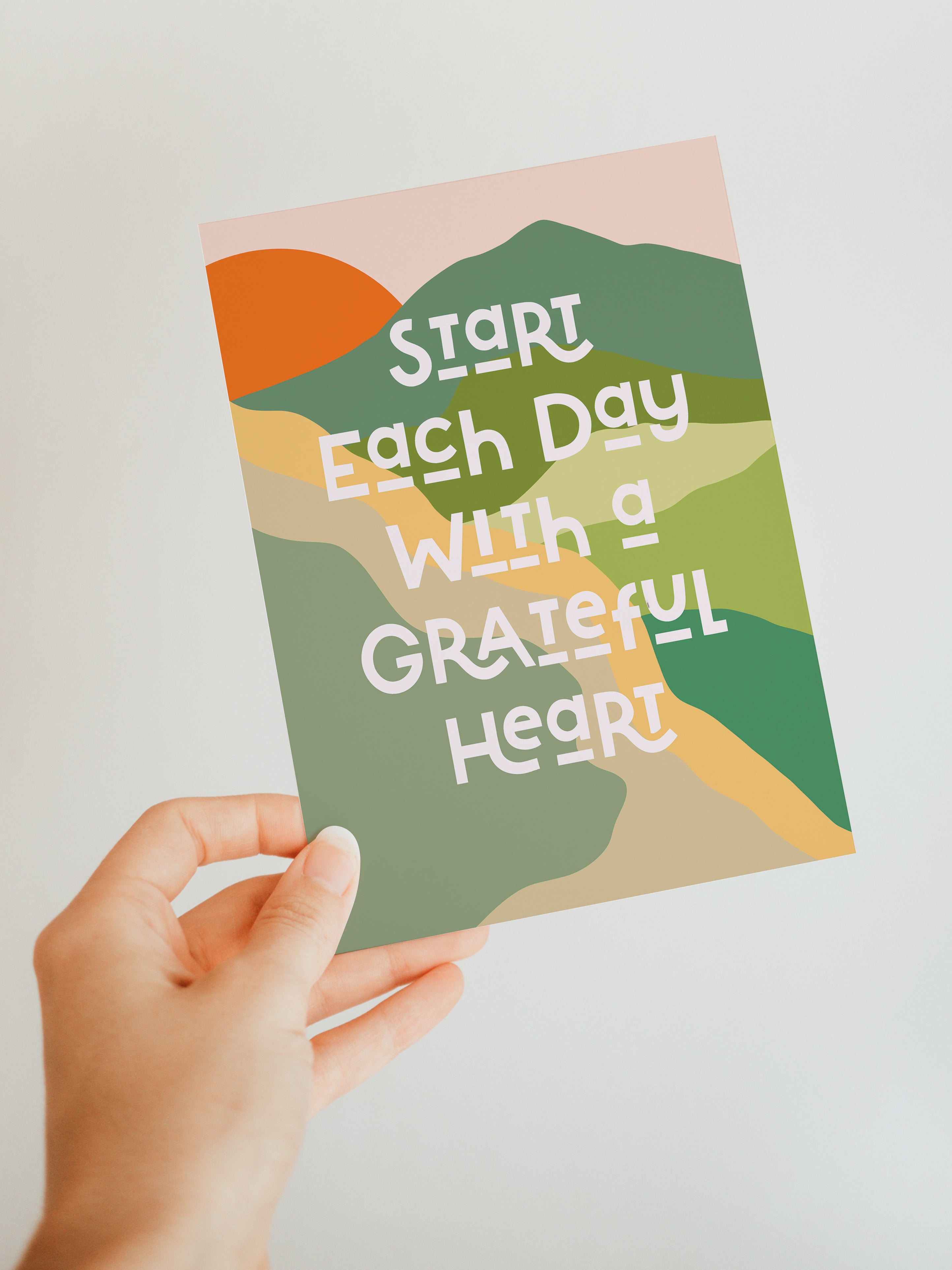 Grateful Heart Blank Note Card laying on a pink surface next to an envelope and a pen