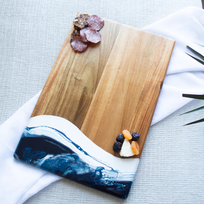 acacia resin serving bread board with fruits on a white towel