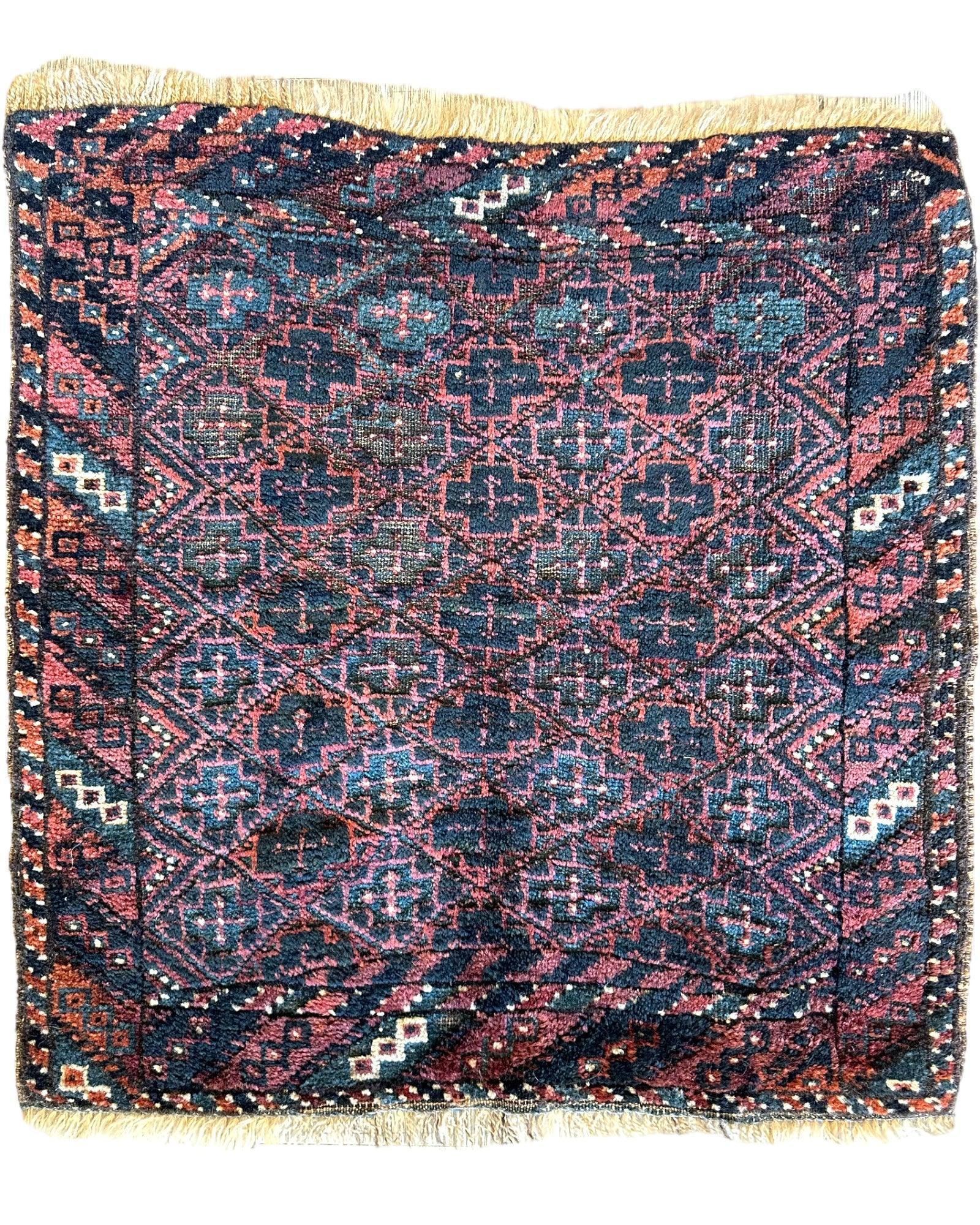 Antique Tribal Baluch Bag Face rug measuring 22 by 24 inches with natural wool pile and tribal design