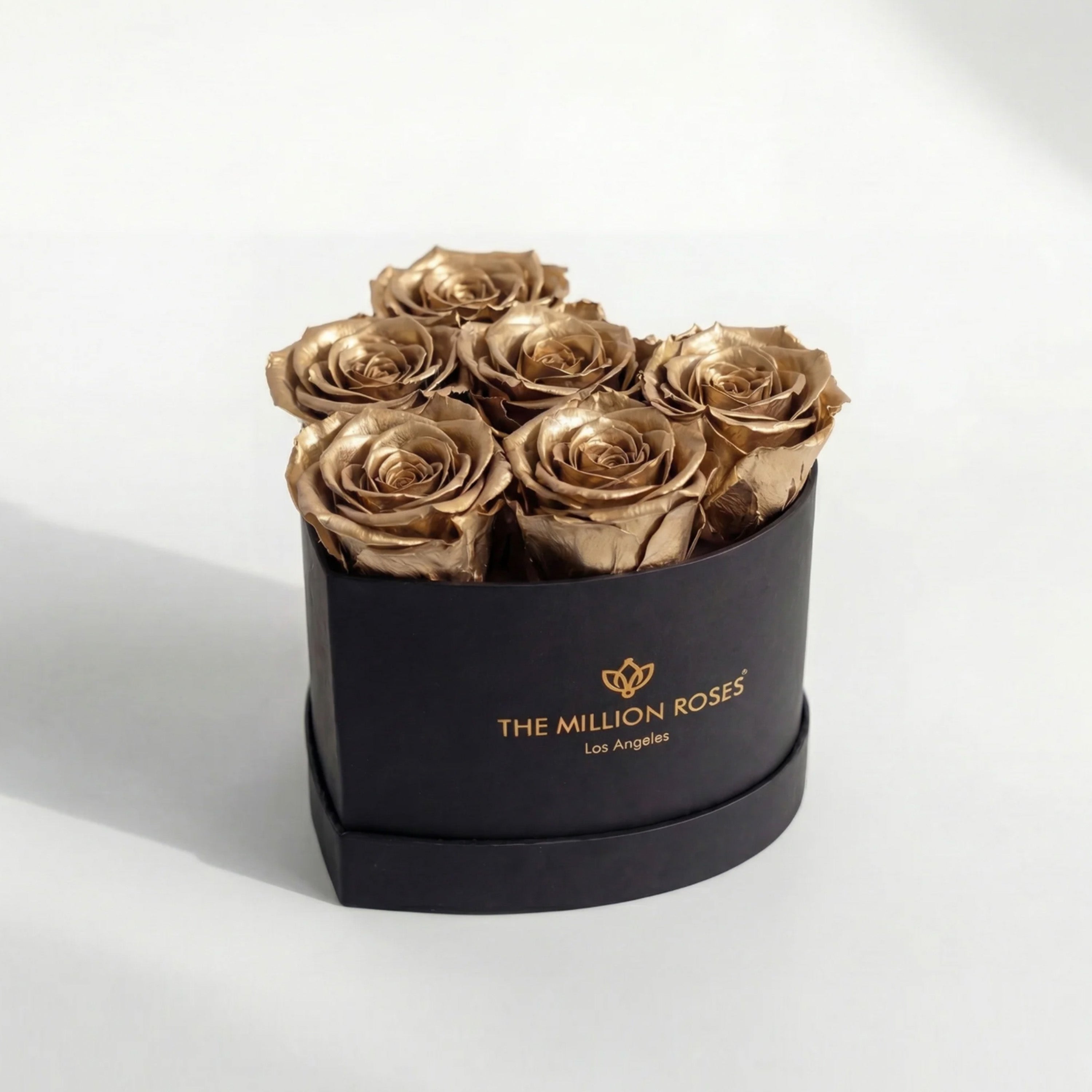 Baby Heart Black Box containing six gold roses arranged in a heart shape