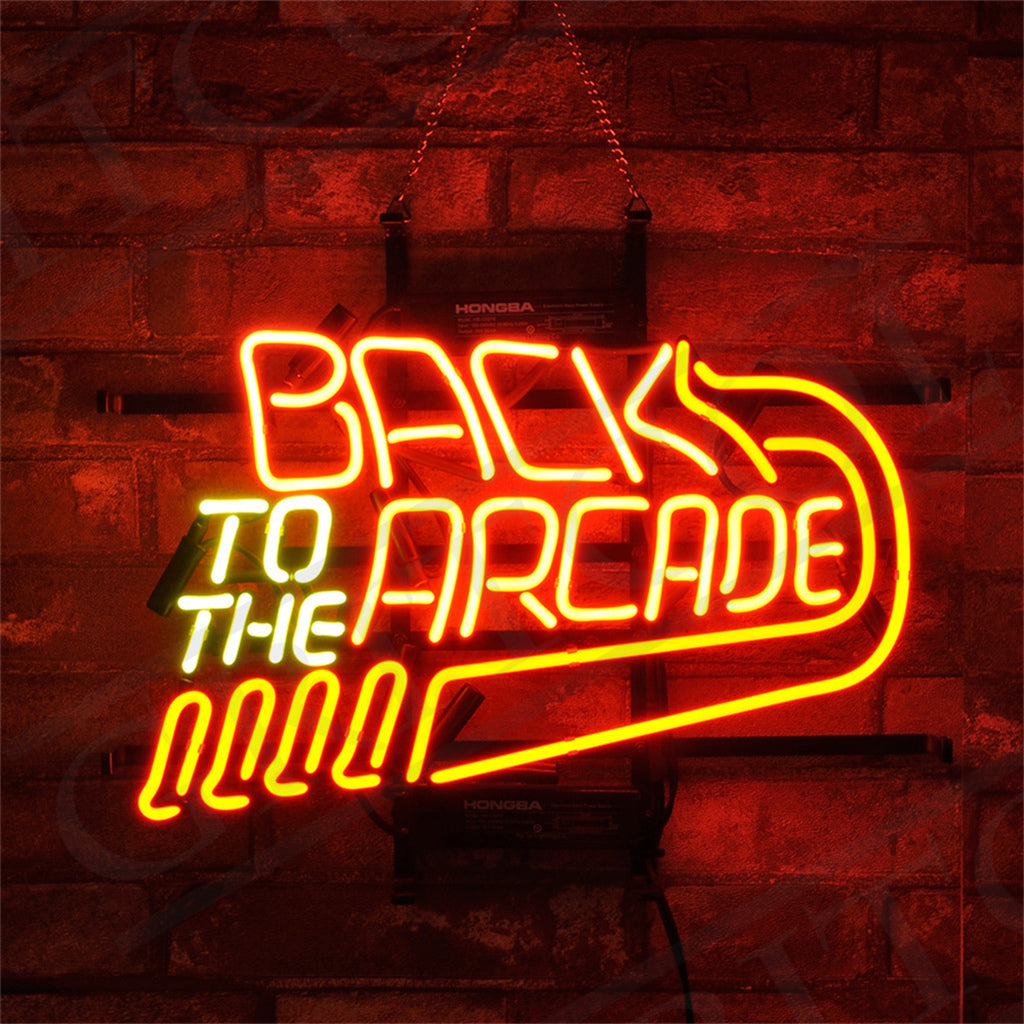 Back to The Arcade Neon Signs glowing against a dark wall, featuring bright neon colors on a metal grid backing.