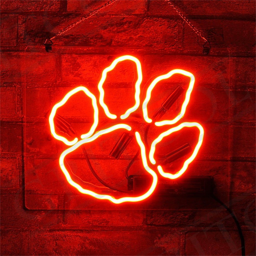 Bear Claw Neon Sign glowing in warm orange light hanging on a wall