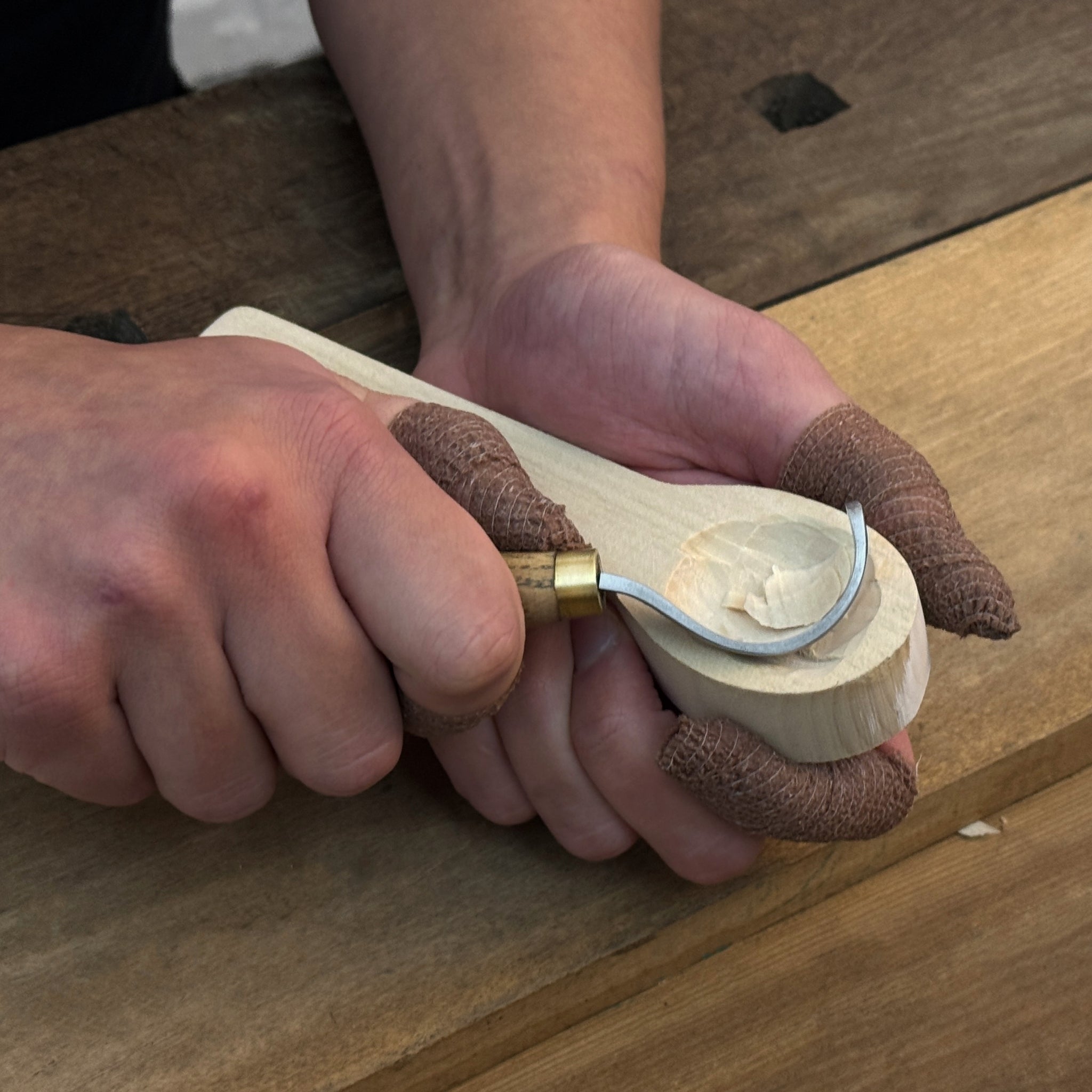 Beginner DIY Spoon Carving Kit with hand-forged knives, linden wood blanks, and carving tools laid out