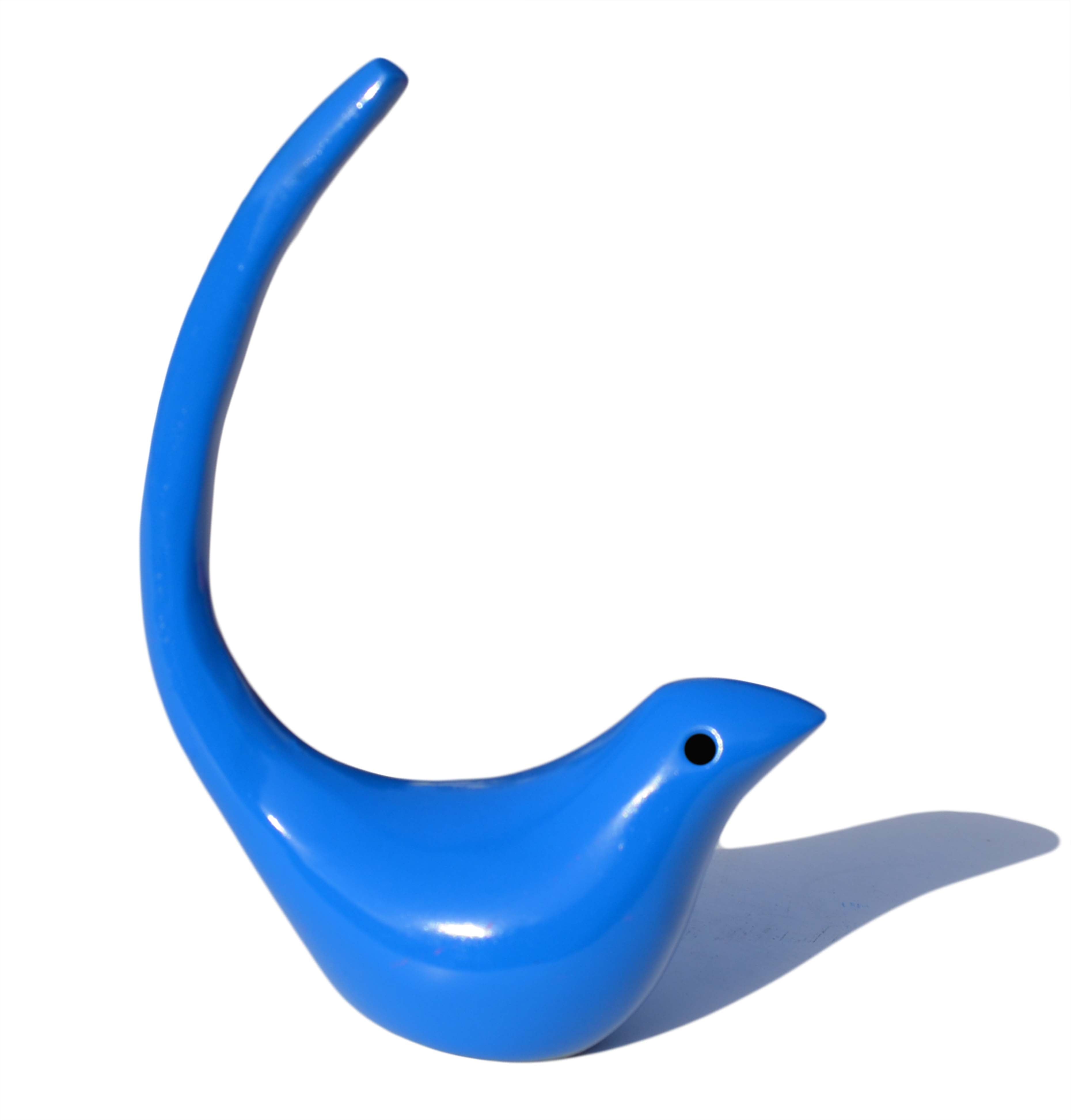 Blue bird figurine ring holder made of aluminum on tabletop
