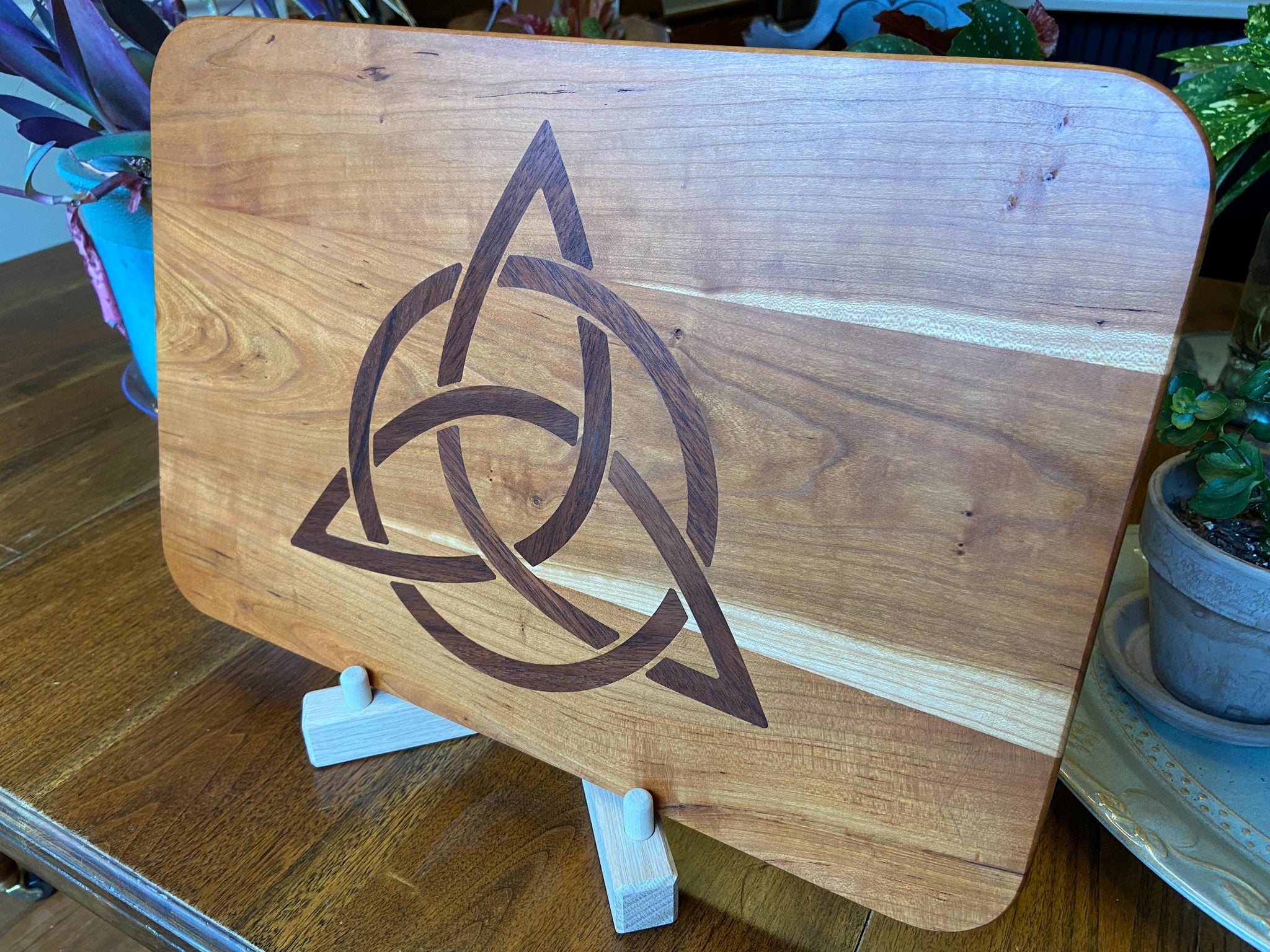 Cherry wood charcuterie board with Celtic Knot triquetra inlay made of Peruvian walnut