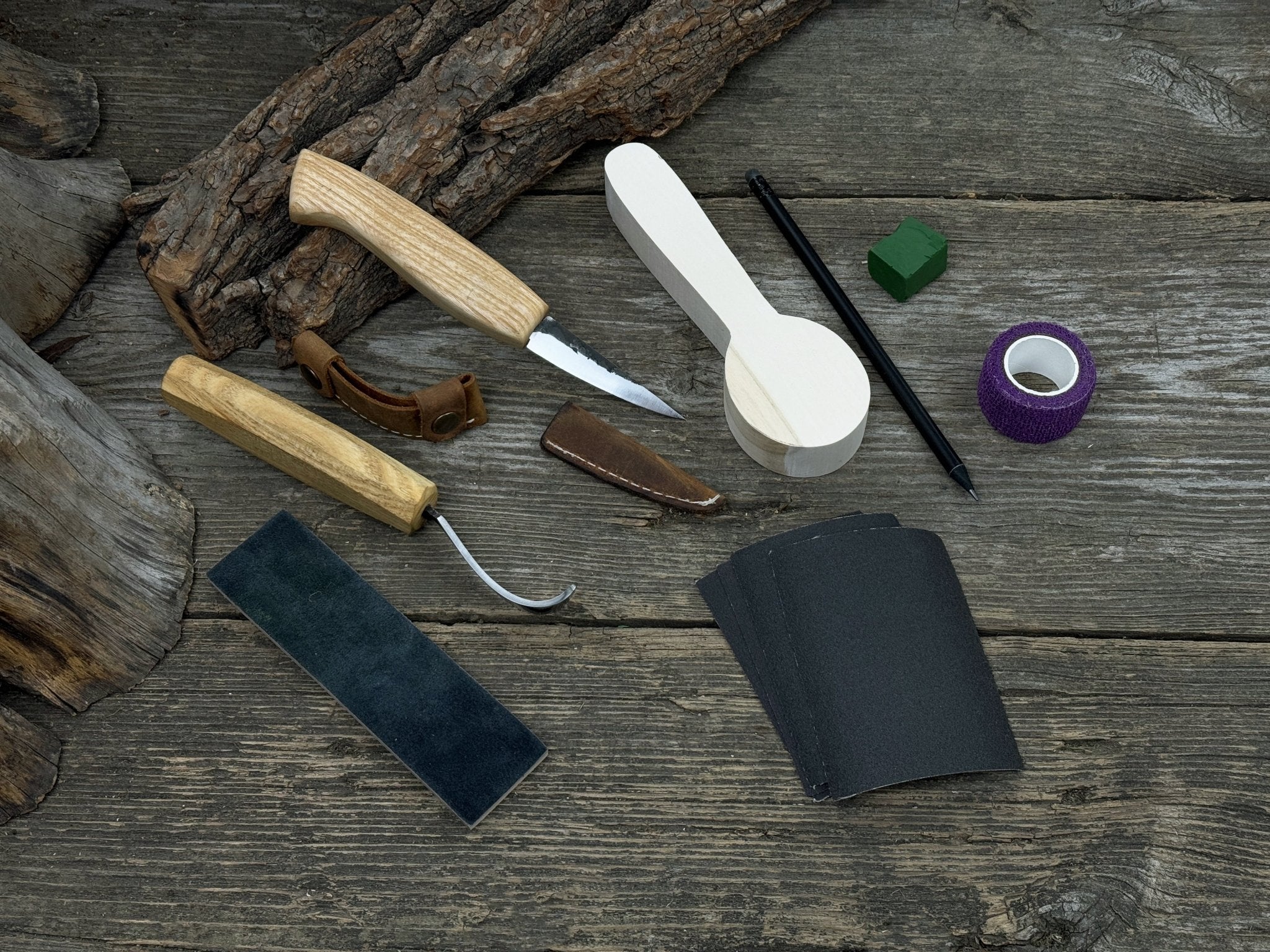 Complete Spoon Carving Kit for Beginners with knives, wooden blank, sandpaper, and sharpening board
