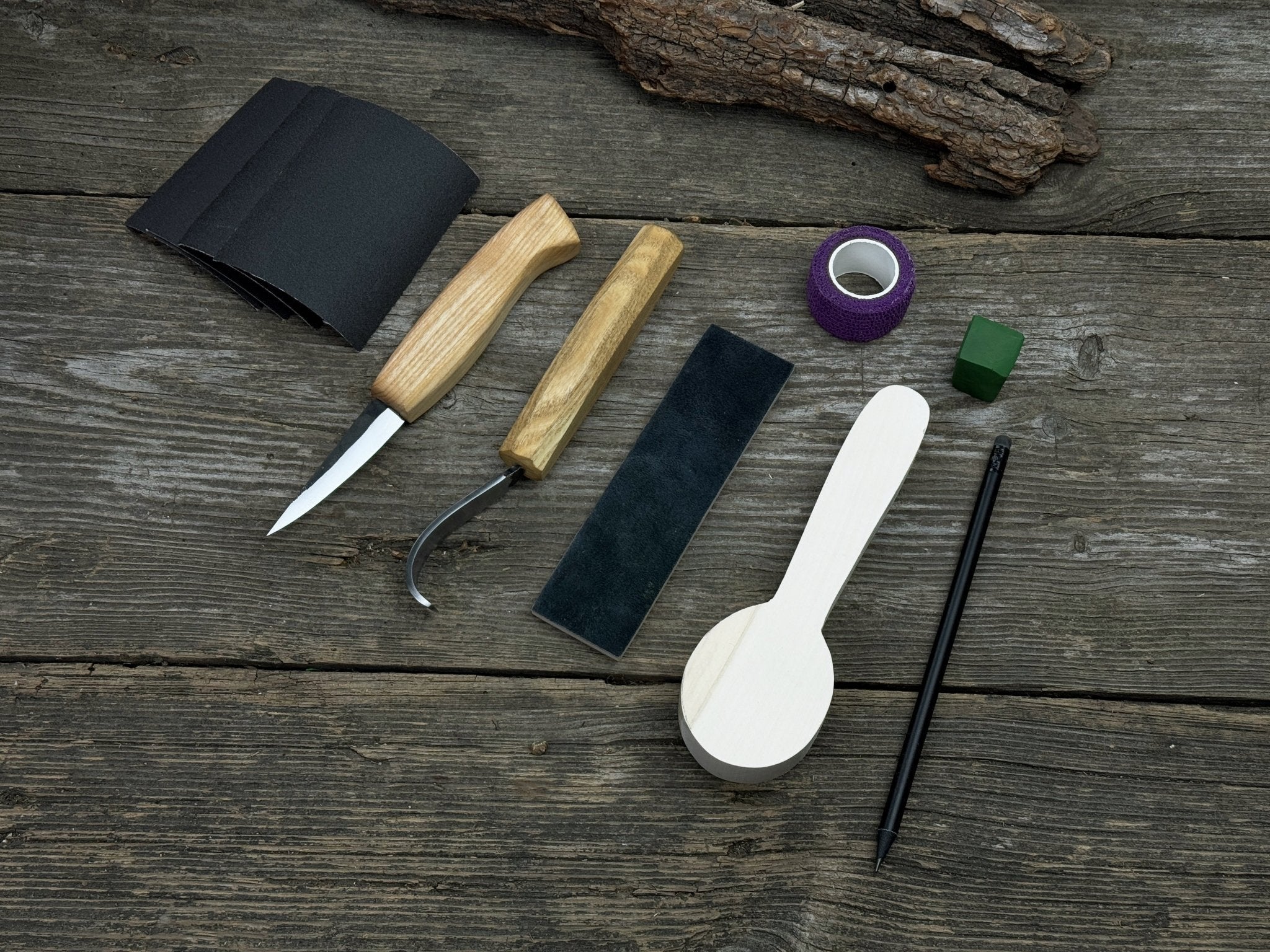 Complete Spoon Carving Kit for Beginners with knives, wooden blank, sandpaper, and sharpening board