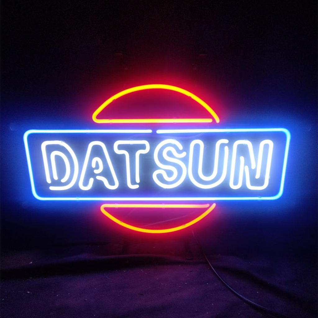 DATSUN Car Neon Sign mounted on a wall, glowing in bright orange hue on metal grid backing