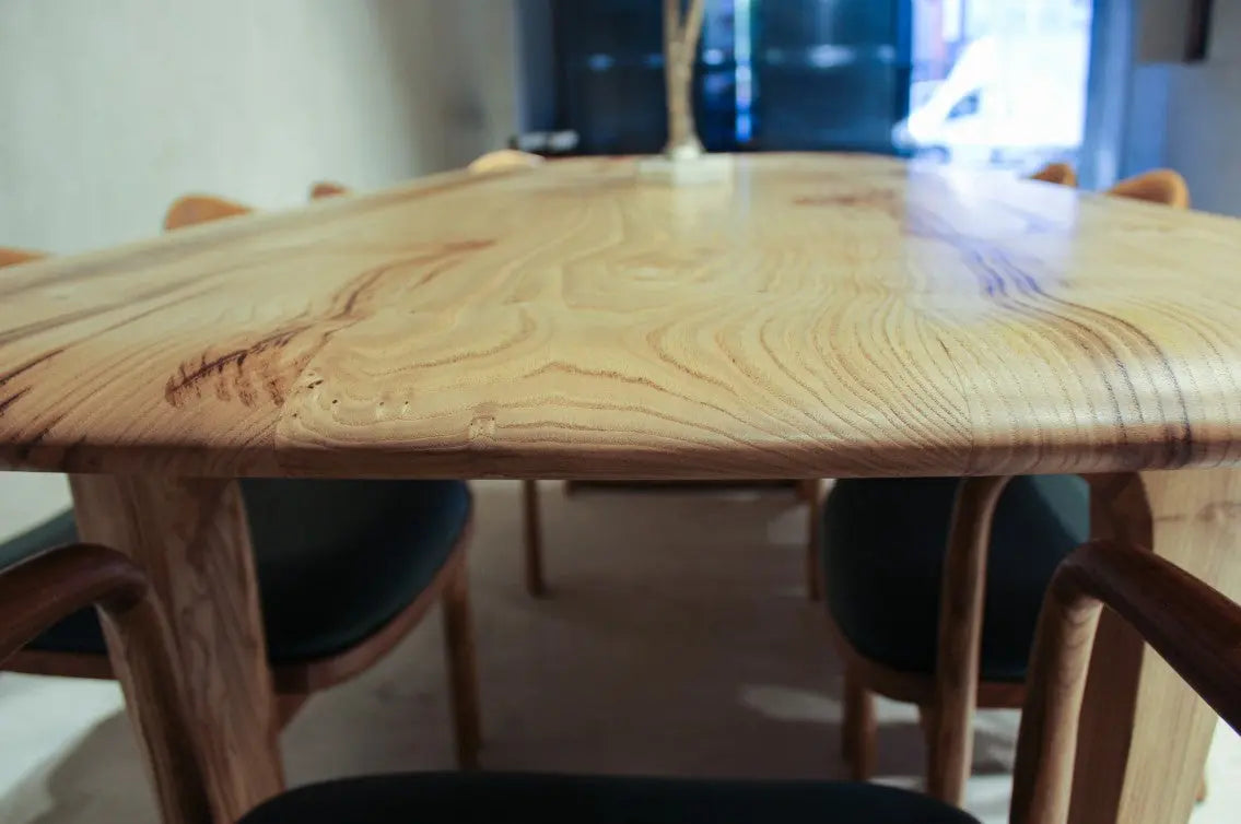 Rustic solid chestnut wood dining table with chestnut legs showing natural grain and knots