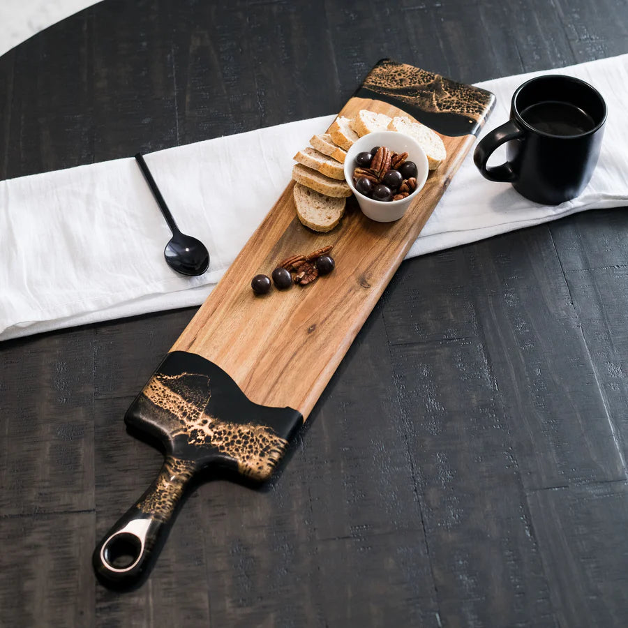 Wooden baguette resin serving tray with bread, nuts, and a cup on a dark surface