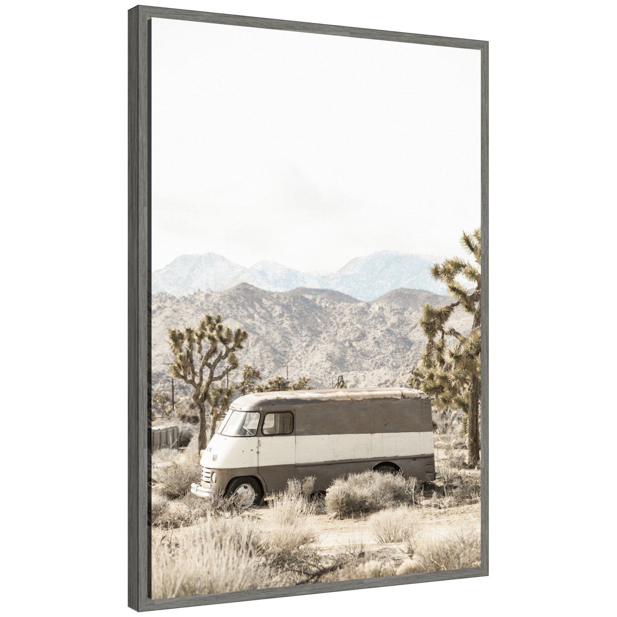 Framed canvas artwork showing a rustic vintage van in a desert landscape with Joshua Tree, by Saint and Sailor Studios.