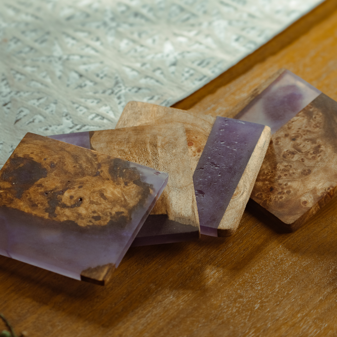 Colorful epoxy handcrafted coasters stacked with visible smooth surfaces and varied artistic patterns.