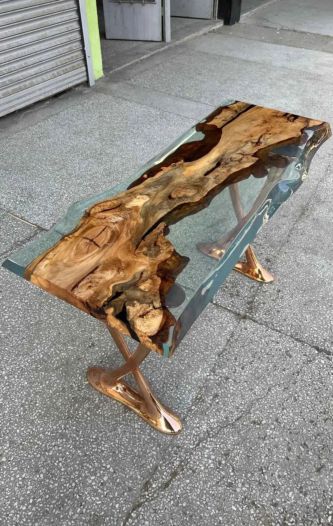 Handcrafted resin live edge console table made of aged linden wood with aluminum legs in a foyer setting