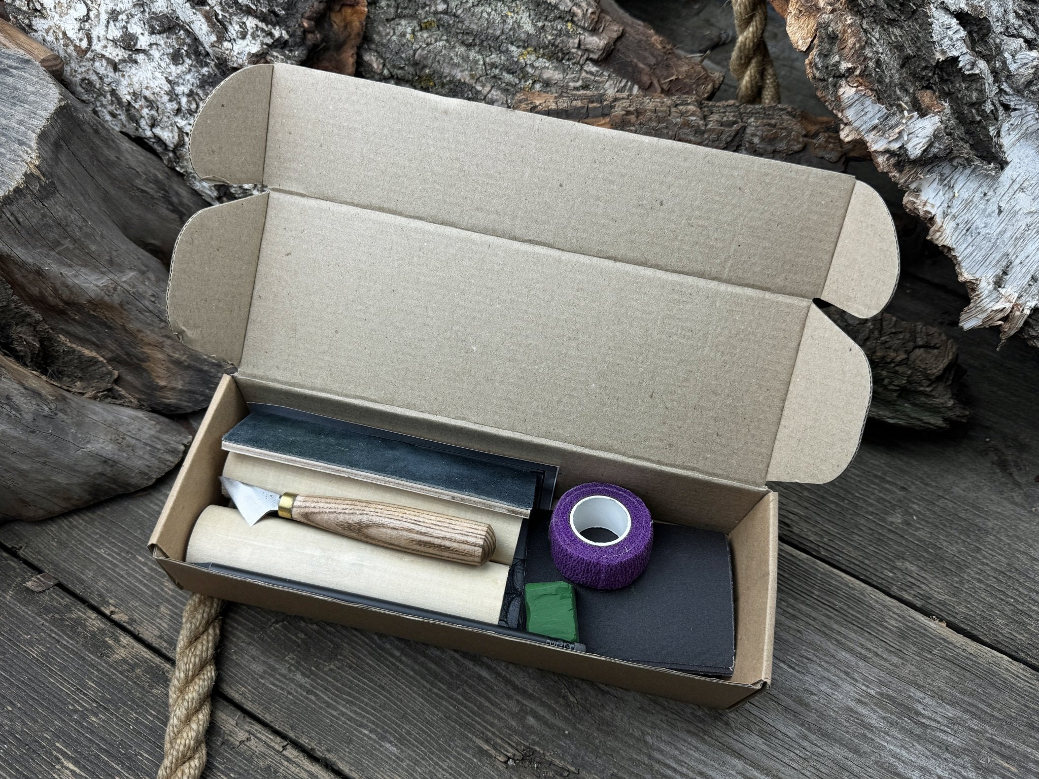 Complete Gnome Carving Kit with knife, wooden blocks, sandpaper, sharpening board, pencil, and gnome drawing template