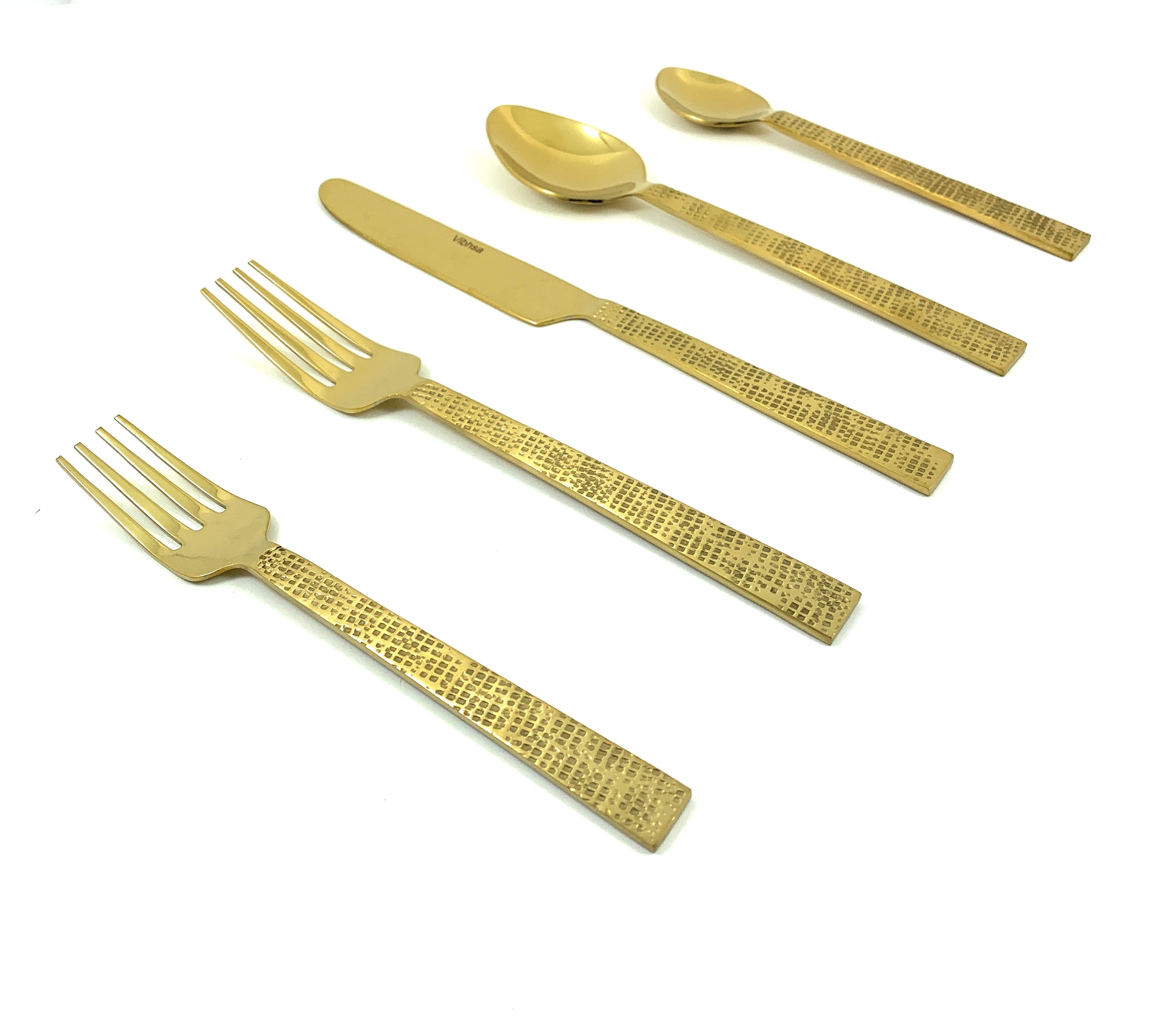 Golden flatware set arranged on a dark surface showcasing forks, knives, spoons with antique golden finish