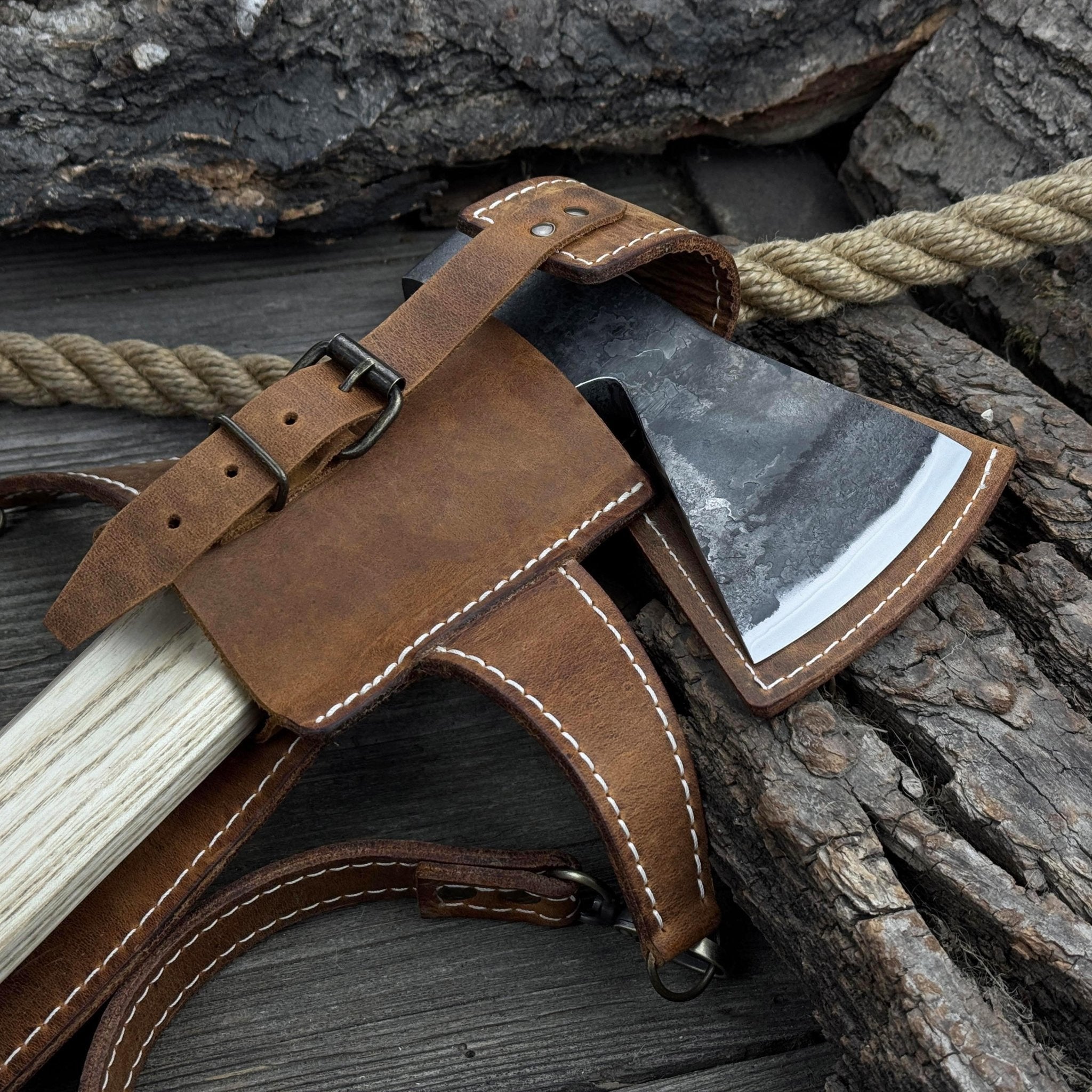 Hand-forged bushcraft hatchet with leather back sheath and ash handle