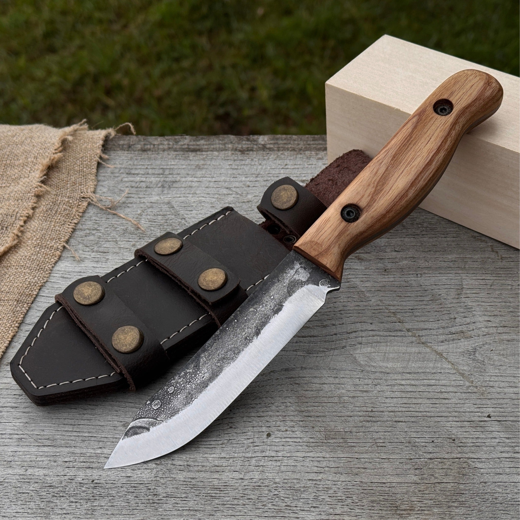 Hand-forged bushcraft knife with 10 cm blade and leather sheath by Sharky Forged Steel Tools