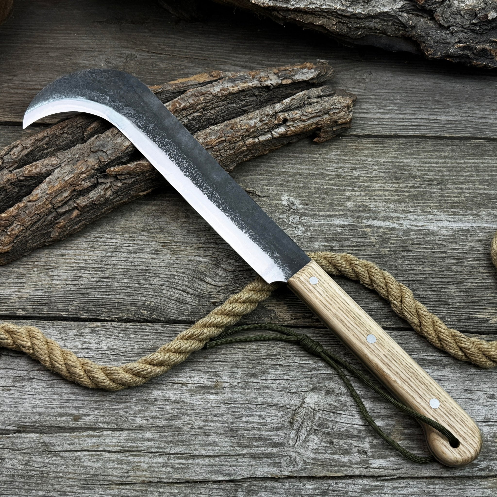 Hand-forged bushcraft knife with carbon steel blade and ash wood handle by Sharky Forged Steel Tools