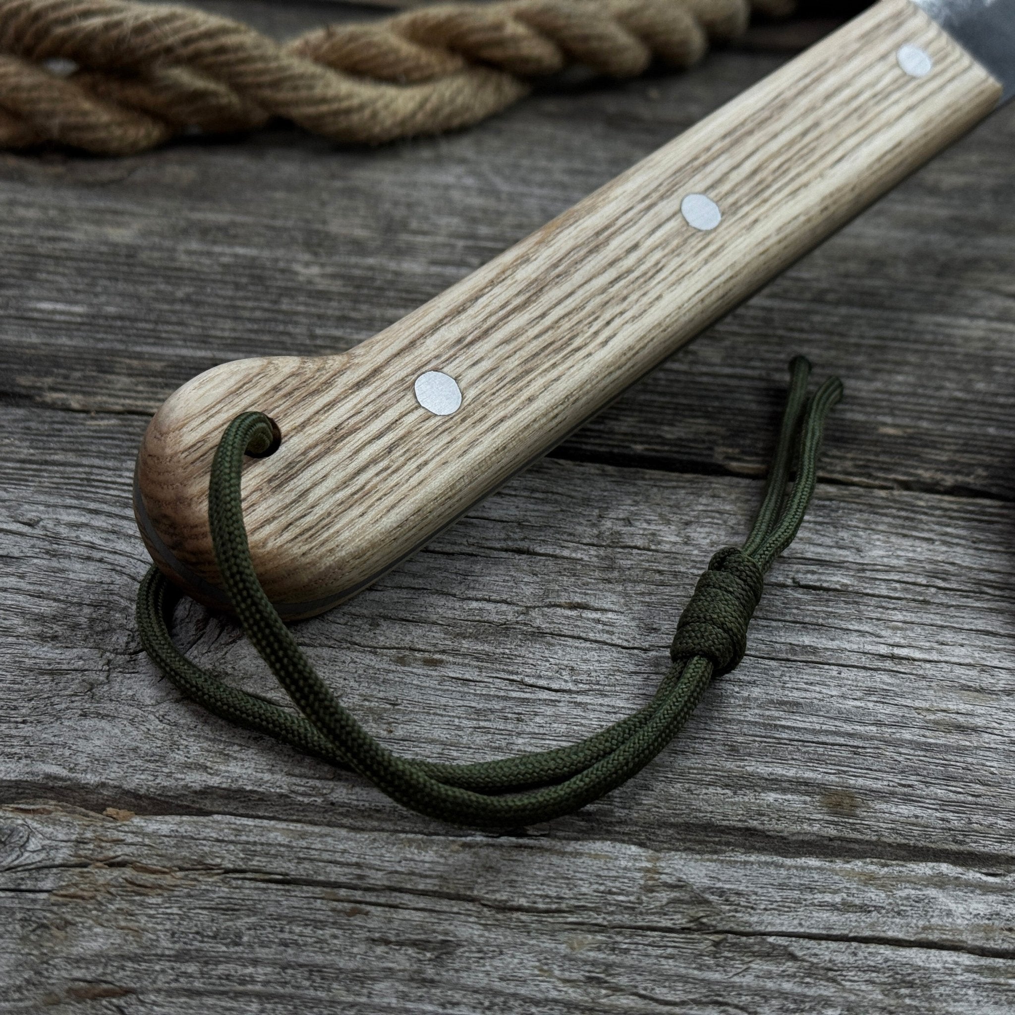 Hand-forged bushcraft knife with carbon steel blade and ash wood handle by Sharky Forged Steel Tools