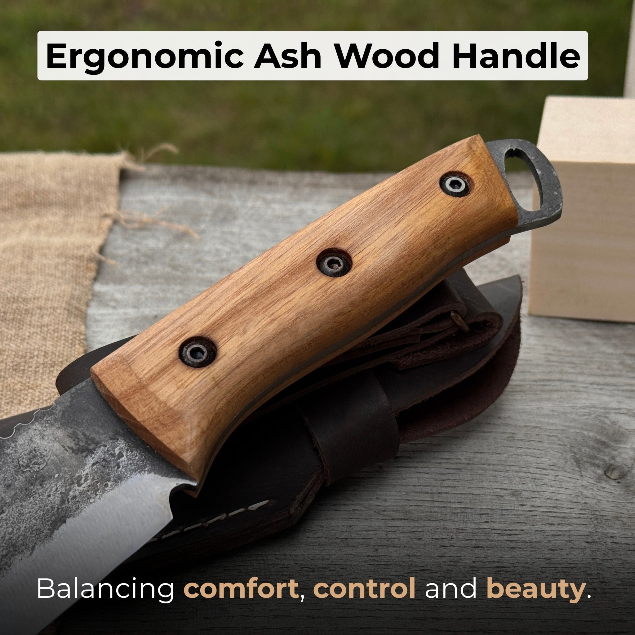 Hand-forged camping knife with 12.5 cm carbon steel blade and ash wood handle, with leather sheath