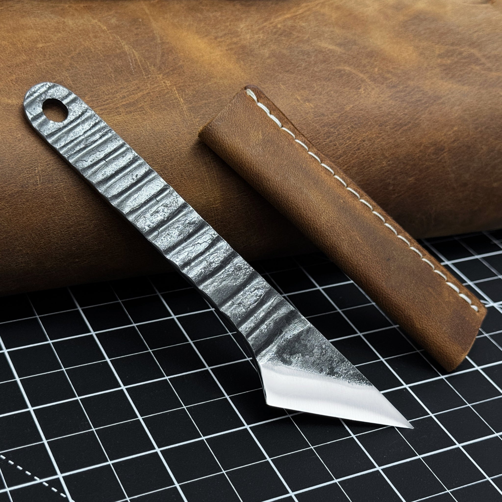 Hand-forged kiridashi knife with razor-sharp carbon steel blade and leather sheath