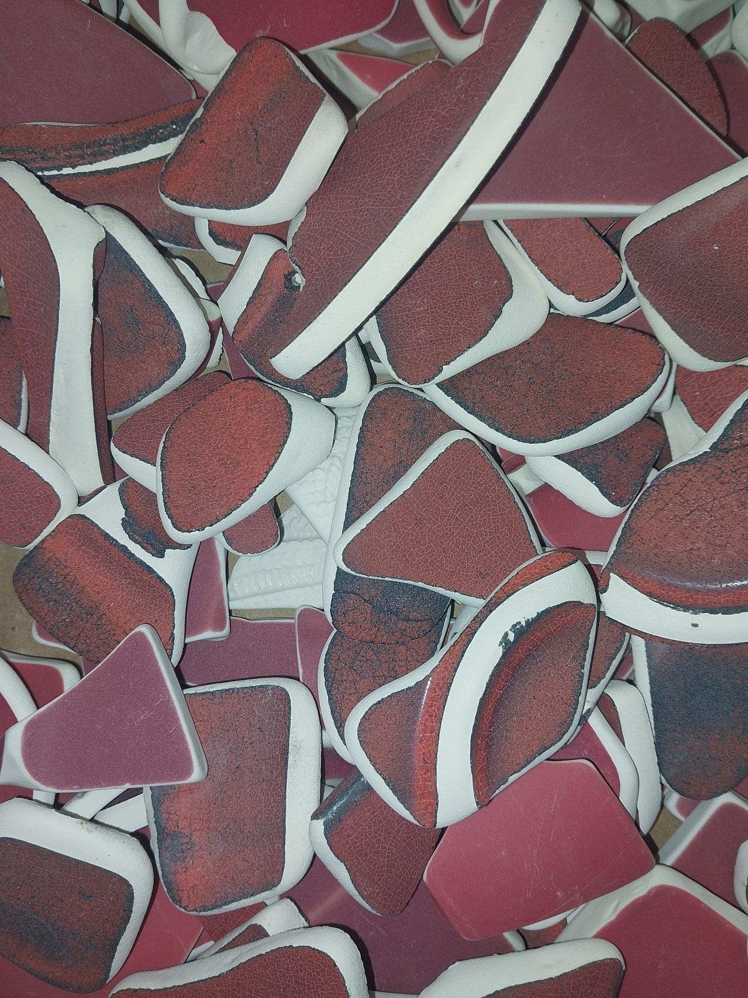Assorted hand-tumbled pottery pieces in earthy colors for mosaic crafts
