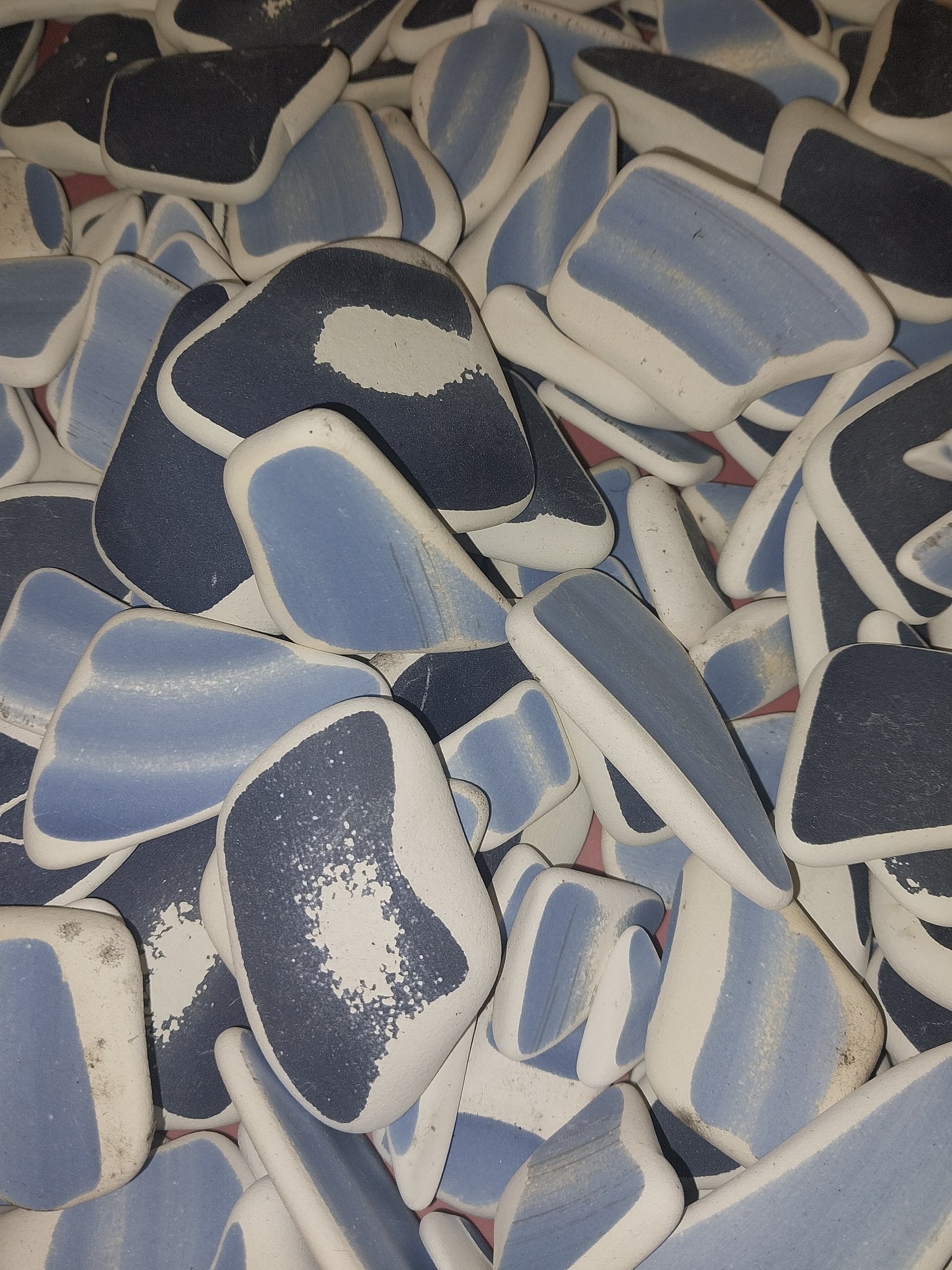 Assorted hand-tumbled pottery pieces in earthy colors for mosaic crafts