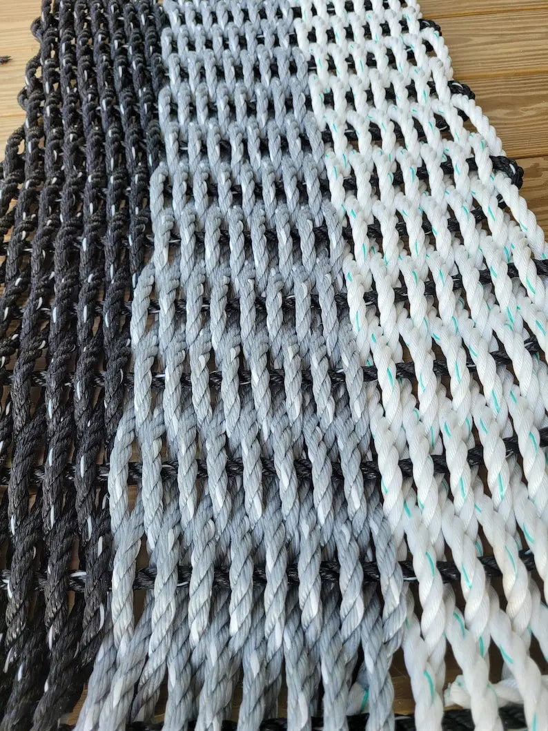 Handmade rope mat made from lobster rope in black, gray, and white colors