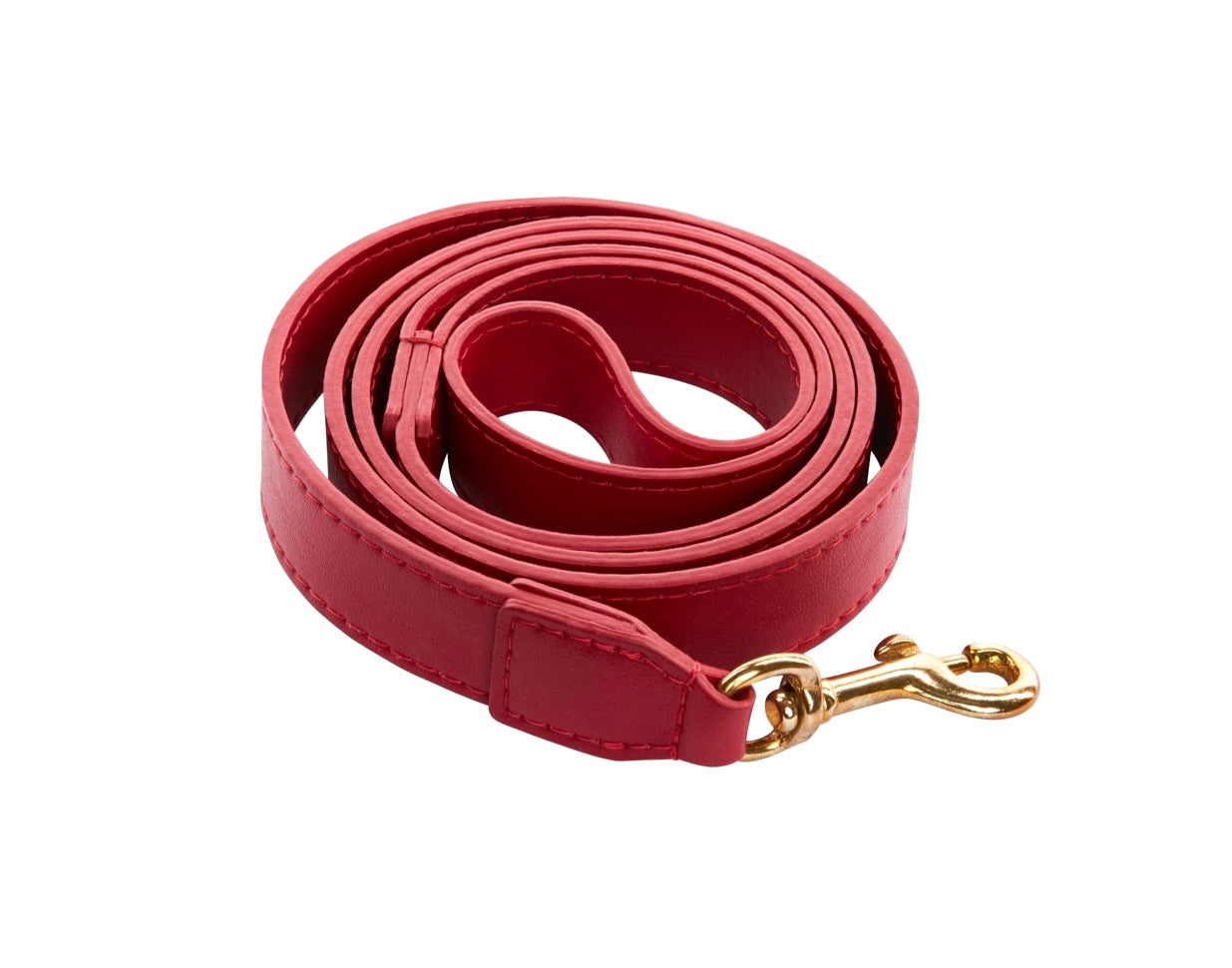 Red vegan leather leash with gold clip laid on a white surface