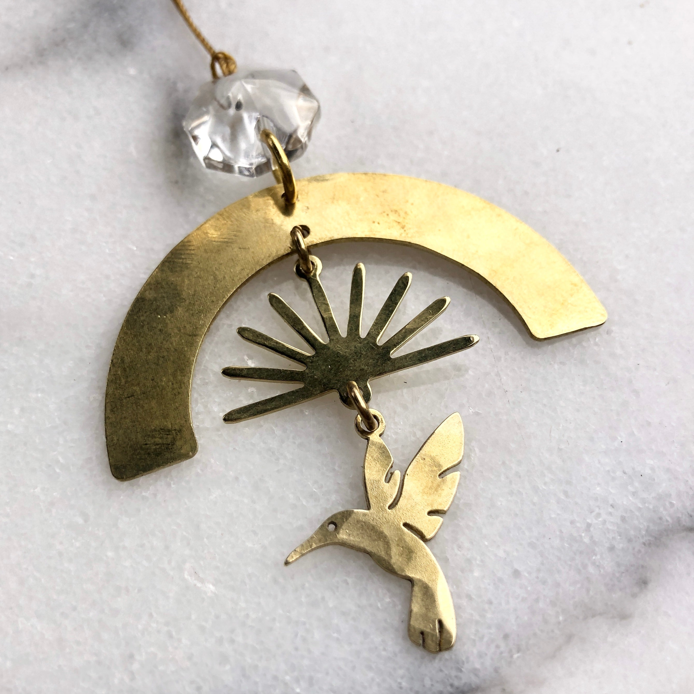 Ascension Ornament with geometric brass shapes and a vintage glass crystal center hanging by a cord