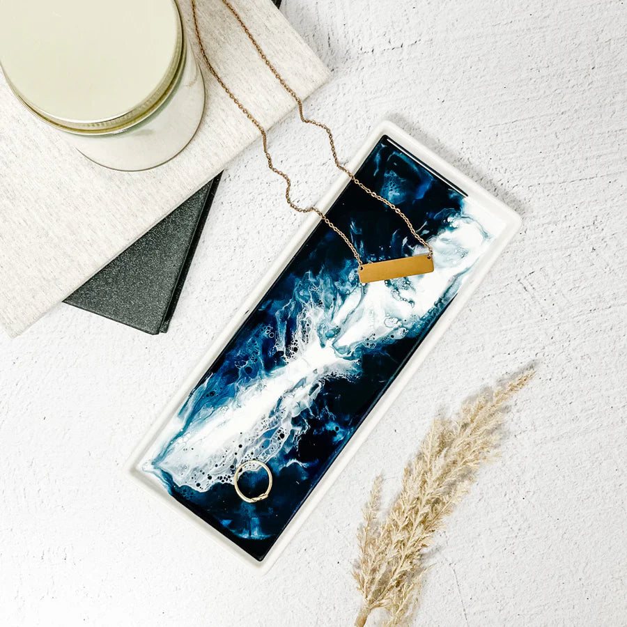 Necklace displayed on a blue and white Small Ceramic Resin Tray with a candle and pampas grass.