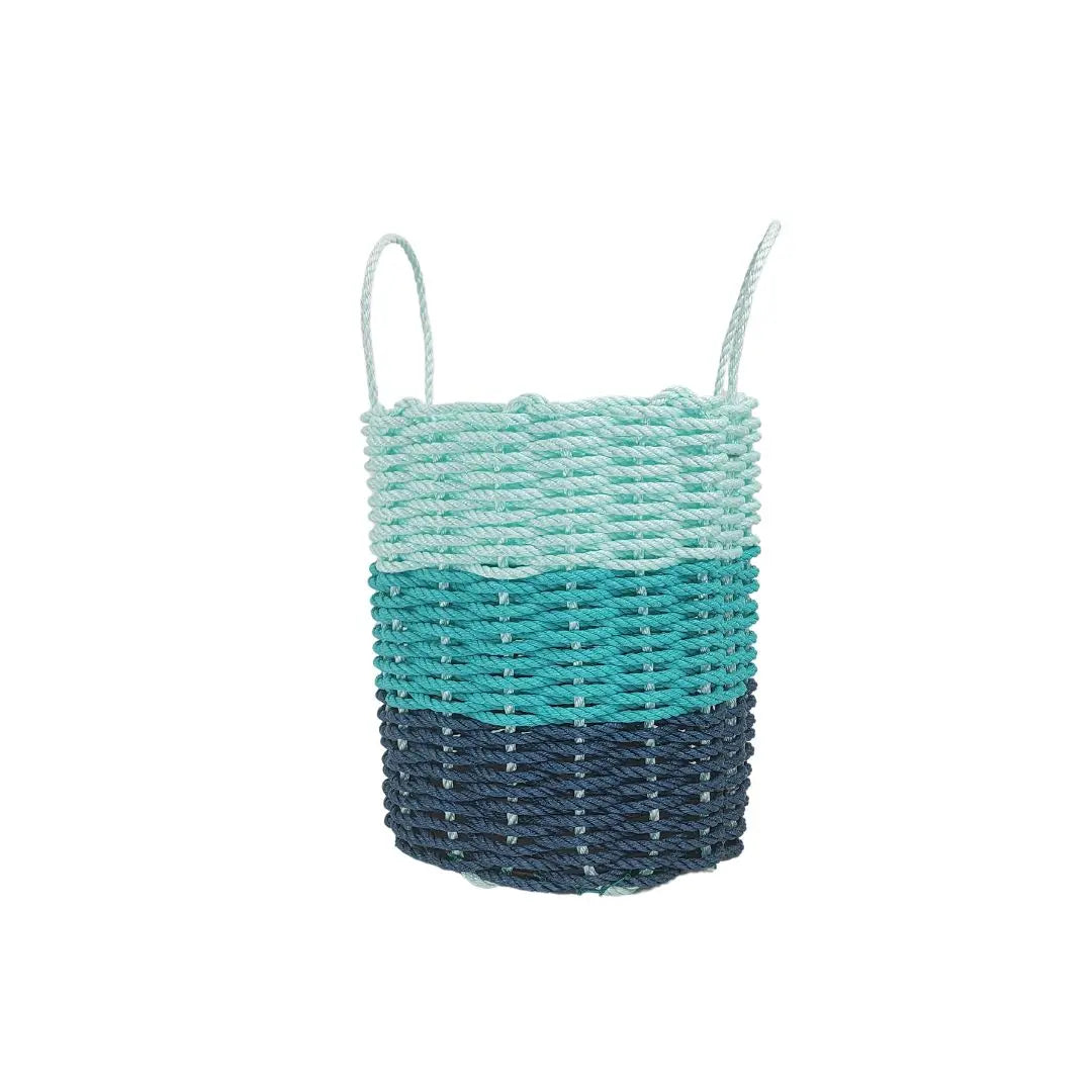 Handmade lobster rope storage baskets in navy blue, teal, and seafoam colors in three sizes