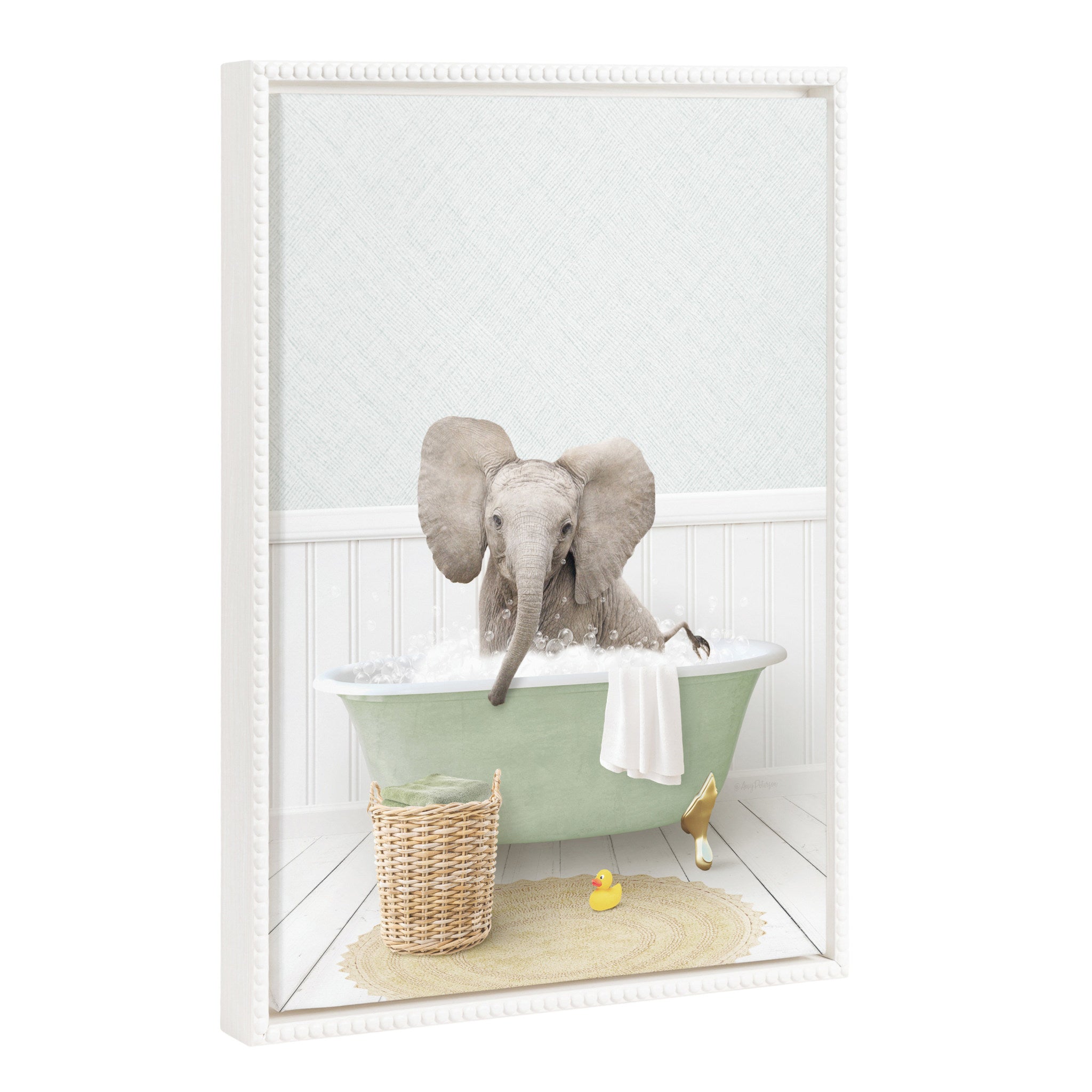 Framed canvas art showing a whimsical baby elephant with big ears in a cottage bath setting, framed with a white vintage beaded polystyrene frame.
