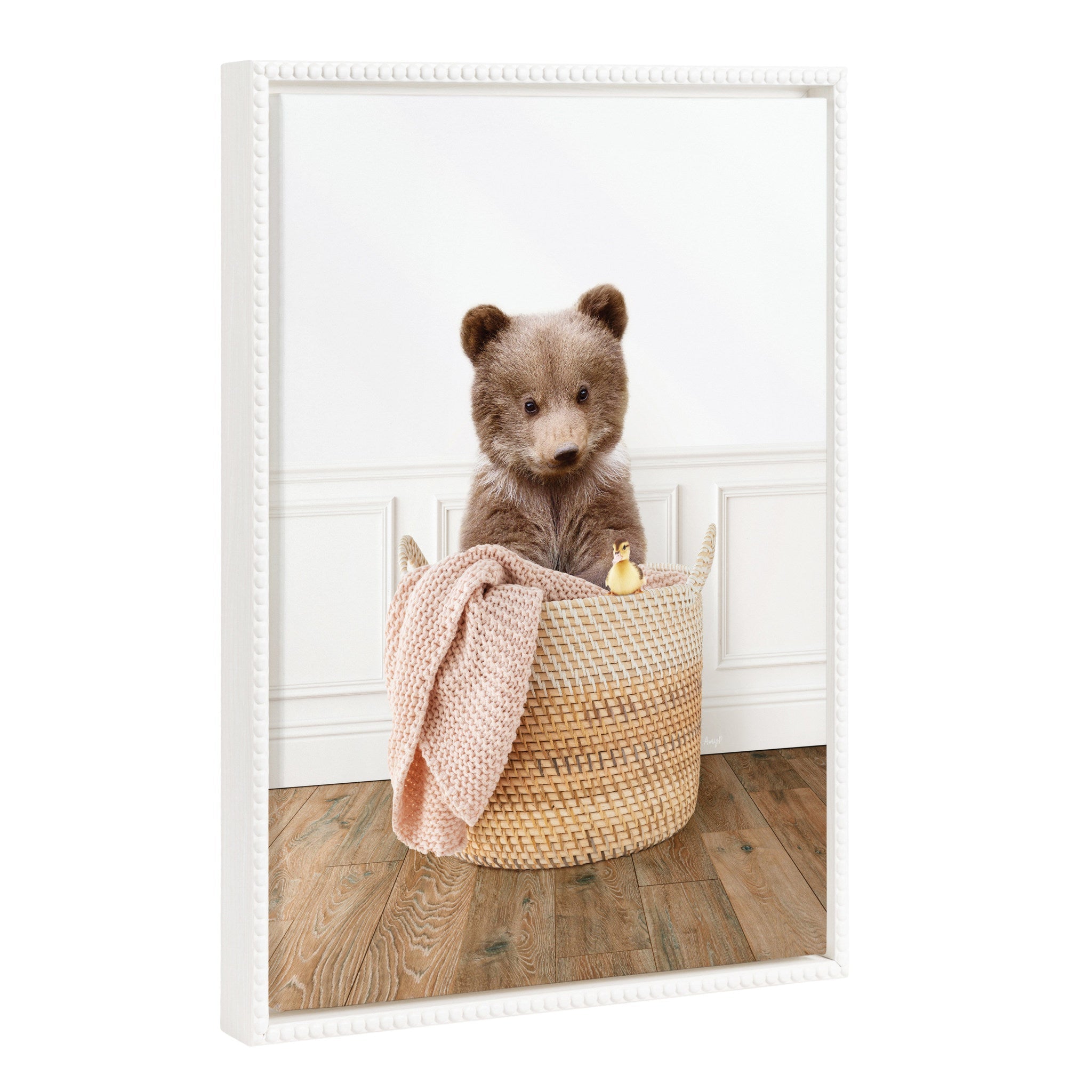 Framed canvas art depicting a bear cub sitting in a laundry basket with a vintage beaded frame