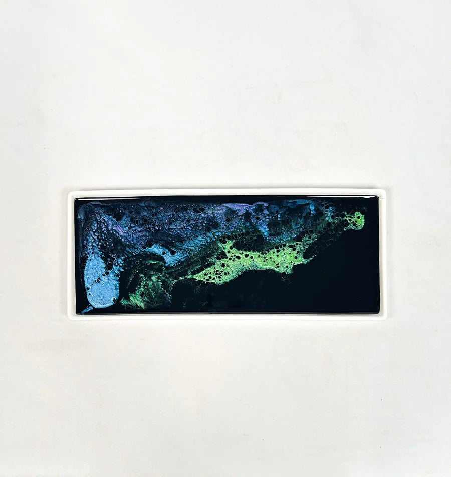 Rectangular resin ceramic tray with a blue and green abstract design on a white background