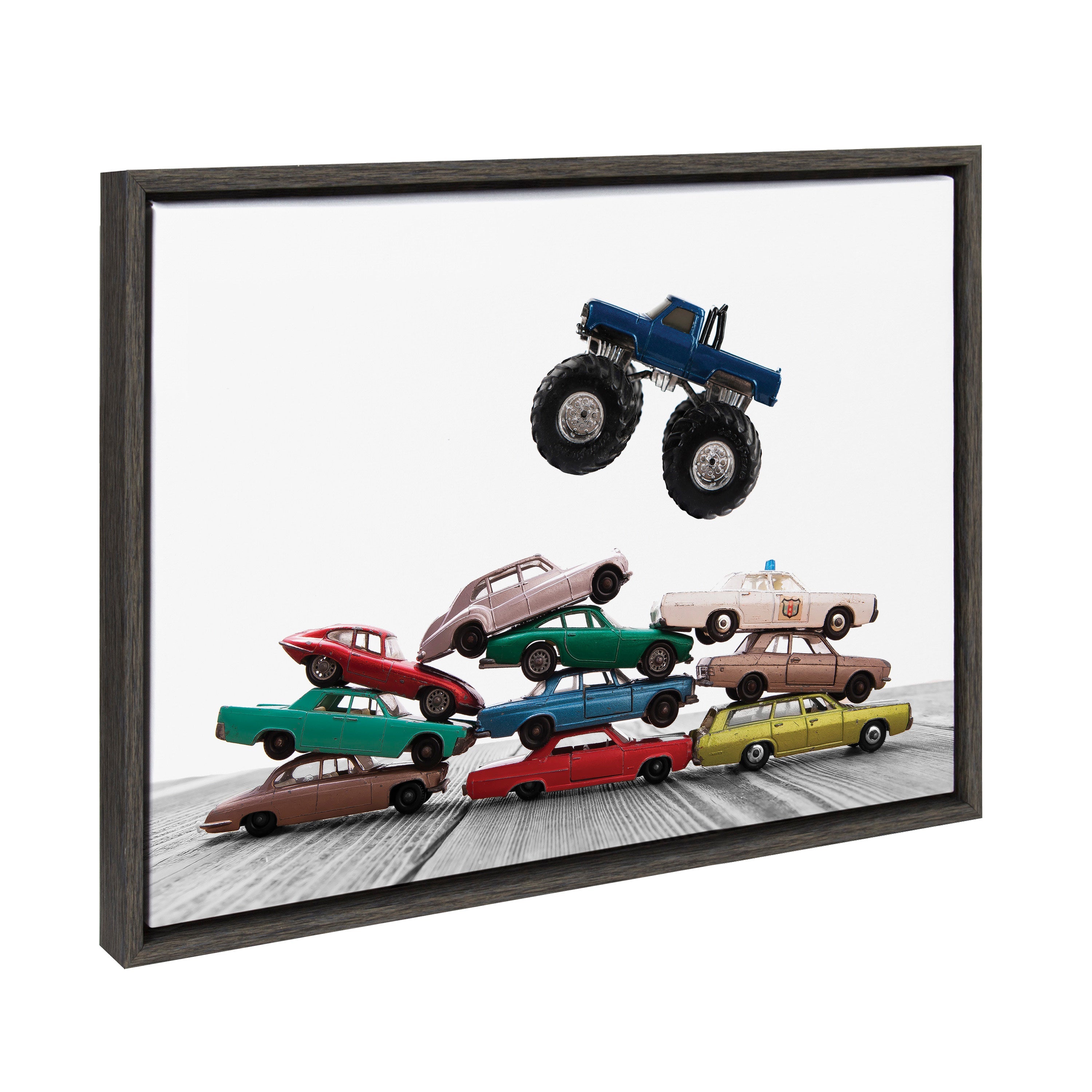 Framed canvas art showing colorful vintage matchbox cars and a monster truck stacked vertically, by Saint and Sailor Studios
