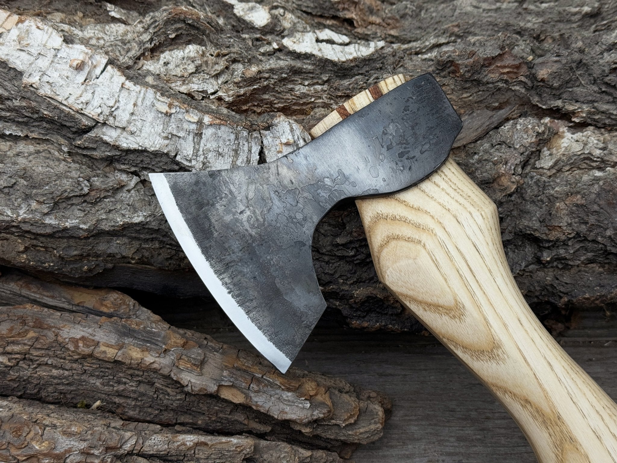 Small carving axe with carbon steel blade and ash wood handle, featuring leather sheath with belt loop