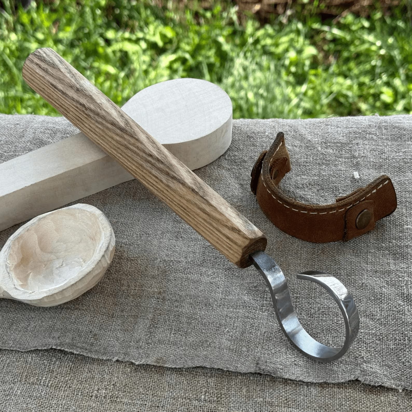Hand-forged spoon carving hook knife with curved blade and ash wood handle