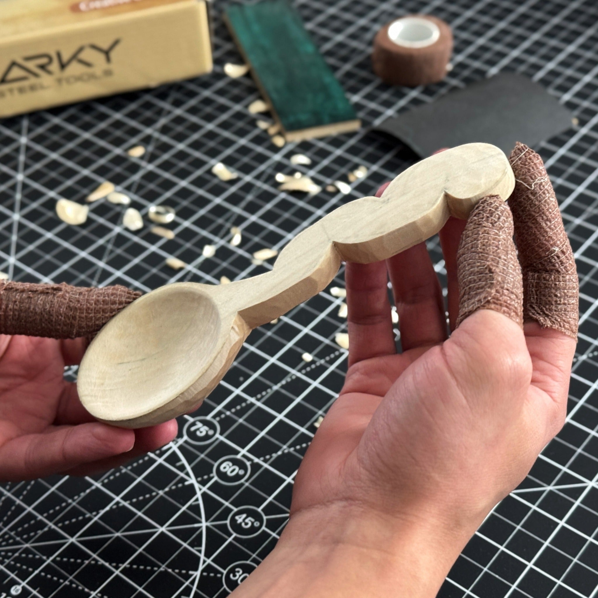 Spoon Carving Kit with wood carving knives, wooden blanks, sandpaper, and sharpening tools