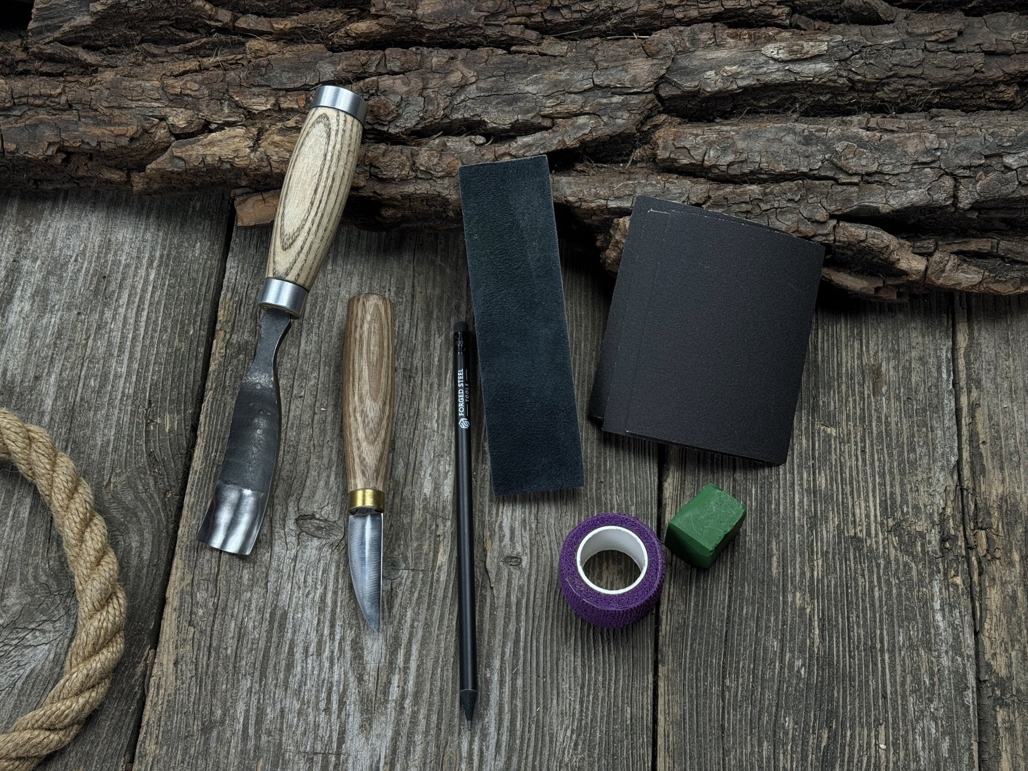 Spoon Carving Kit with hand-forged tools, wooden blanks, sandpaper, and sharpening board
