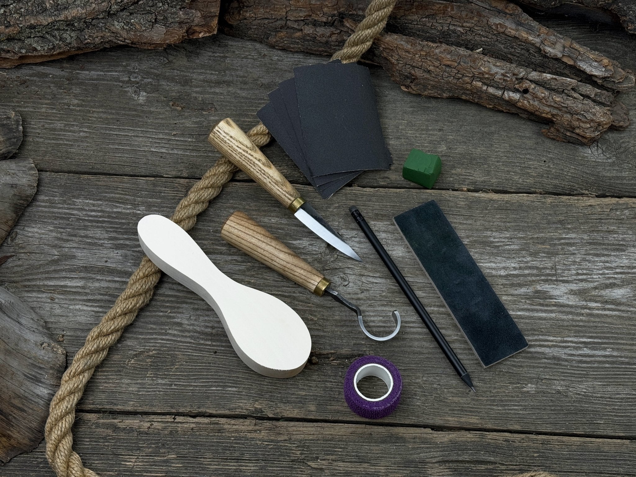 Spoon Carving Kit for Beginners with knives, wooden blank, sandpaper, and sharpening board