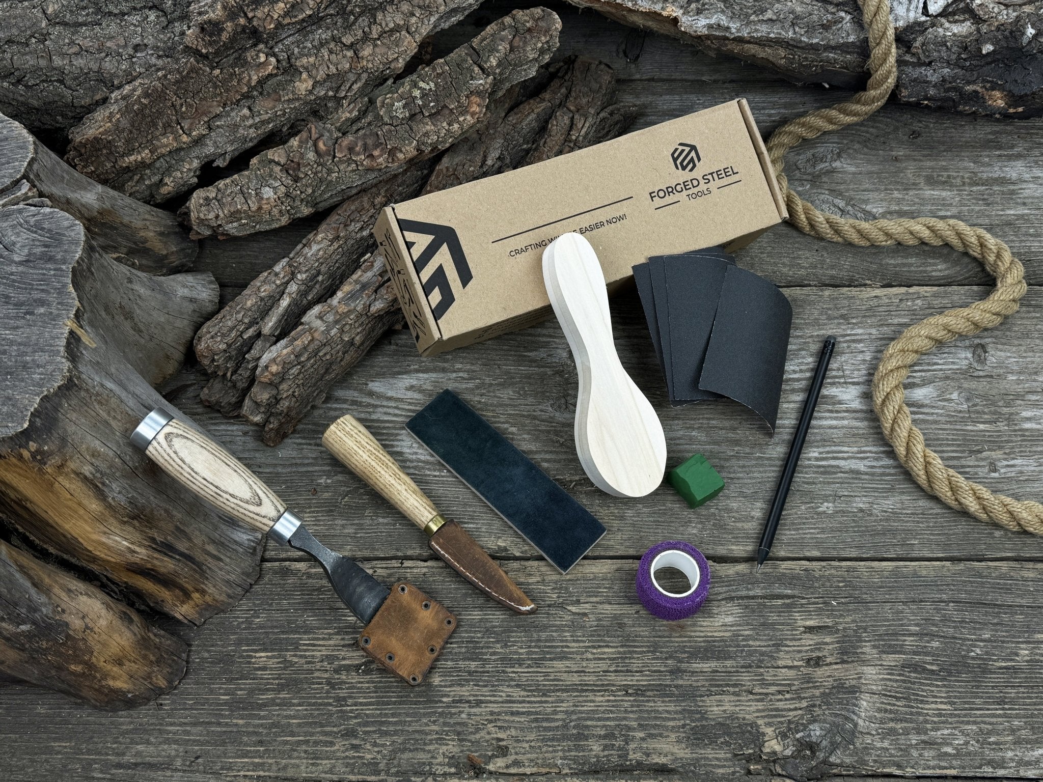 Spoon carving kit with sharpened tools, wooden blank, sandpaper, sharpening board, pencil, and finger wrap