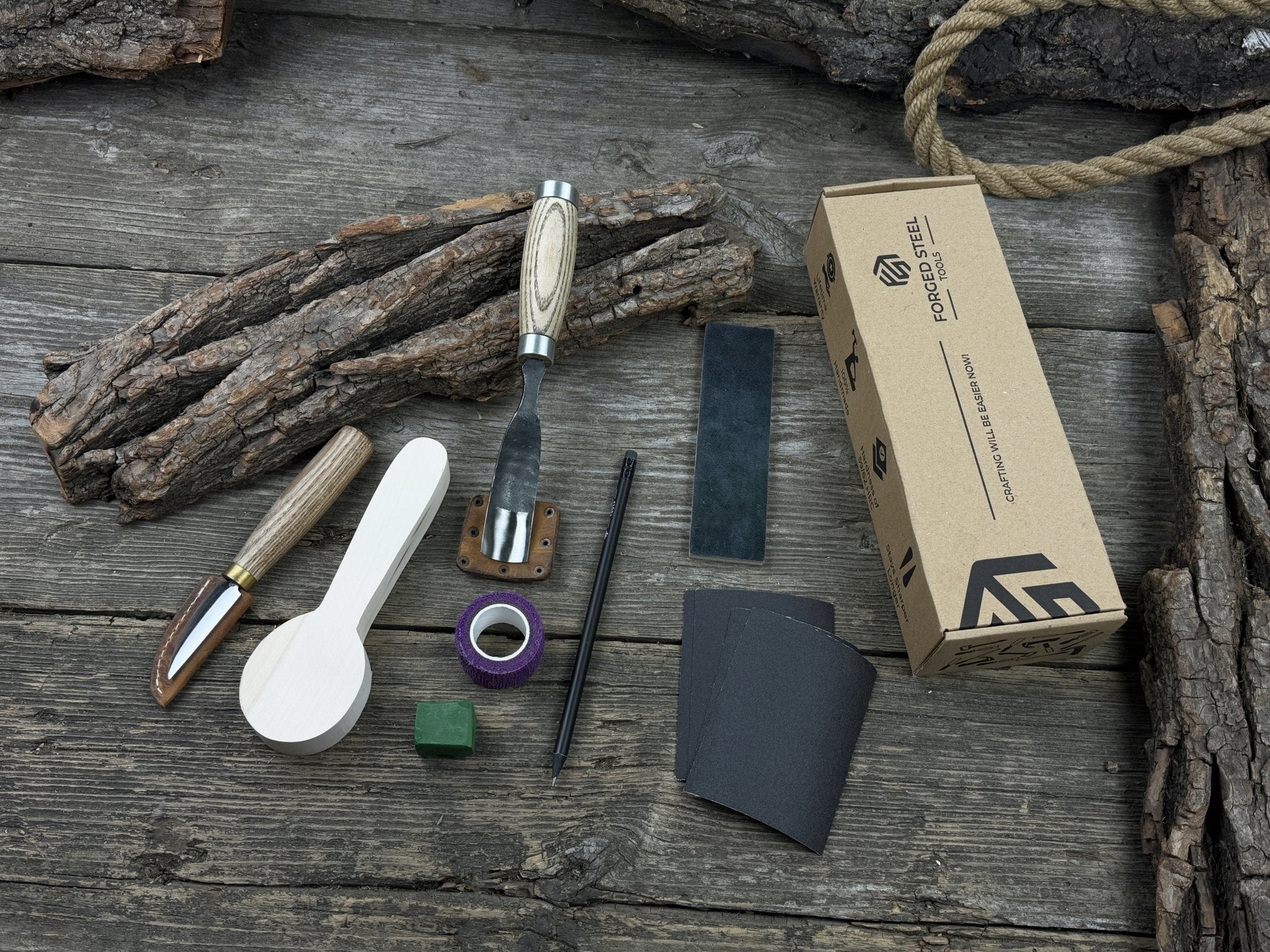 The Perfect Spoon Carving Kit for Beginners with tools, wooden blank, sandpaper, and sharpening board