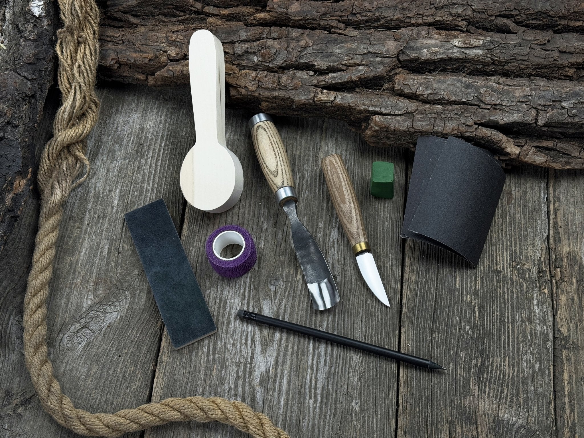 The Perfect Spoon Carving Kit for Beginners with tools, wooden blank, sandpaper, and sharpening board